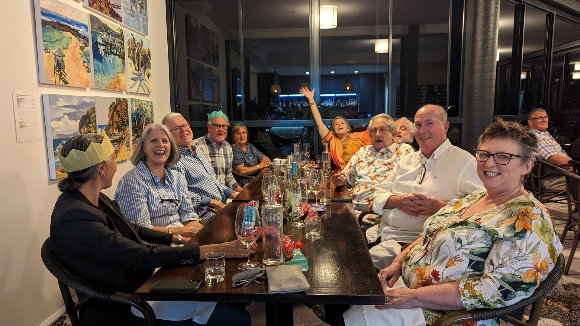 A group of people are sitting at a long table.