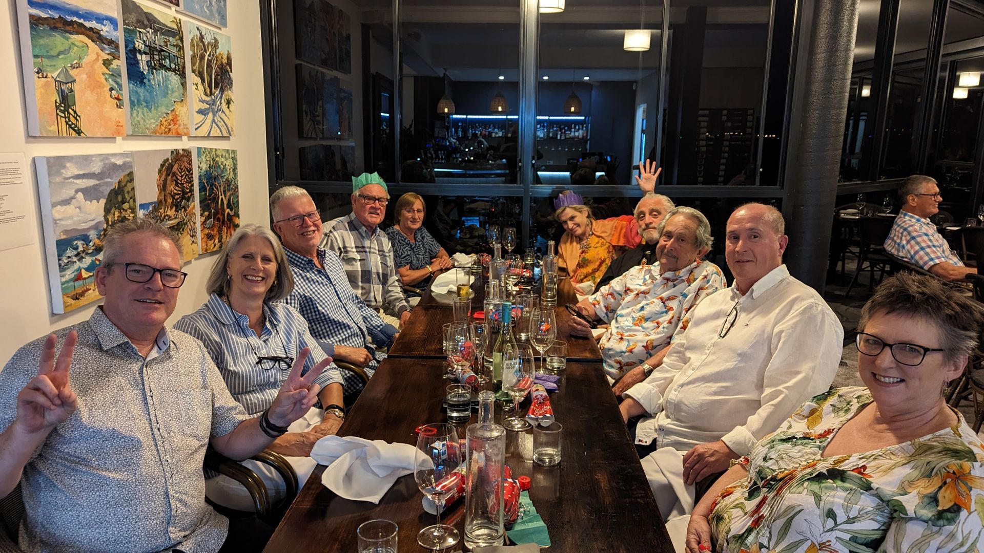 A group of people are sitting at a long table.