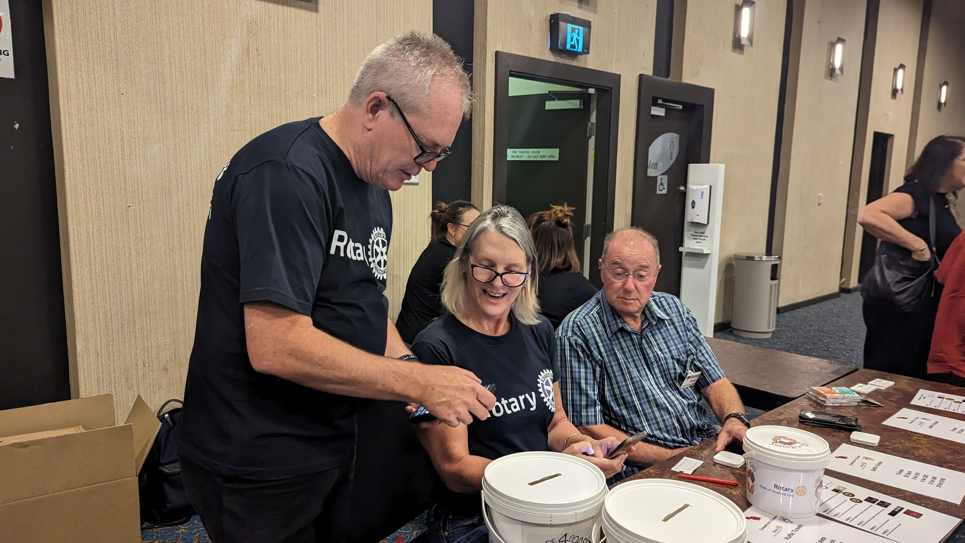 A group of people are sitting at a table in a room.