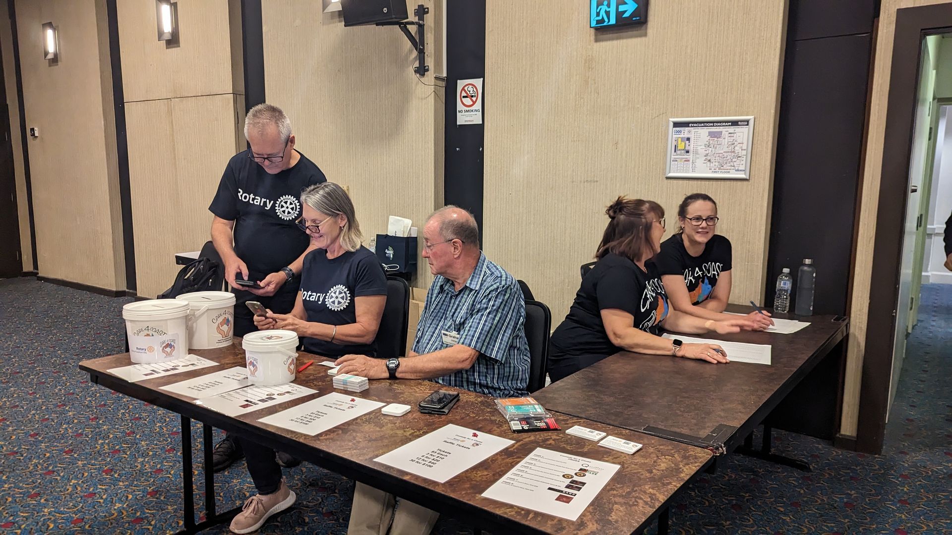 A group of people are sitting at tables in a room.