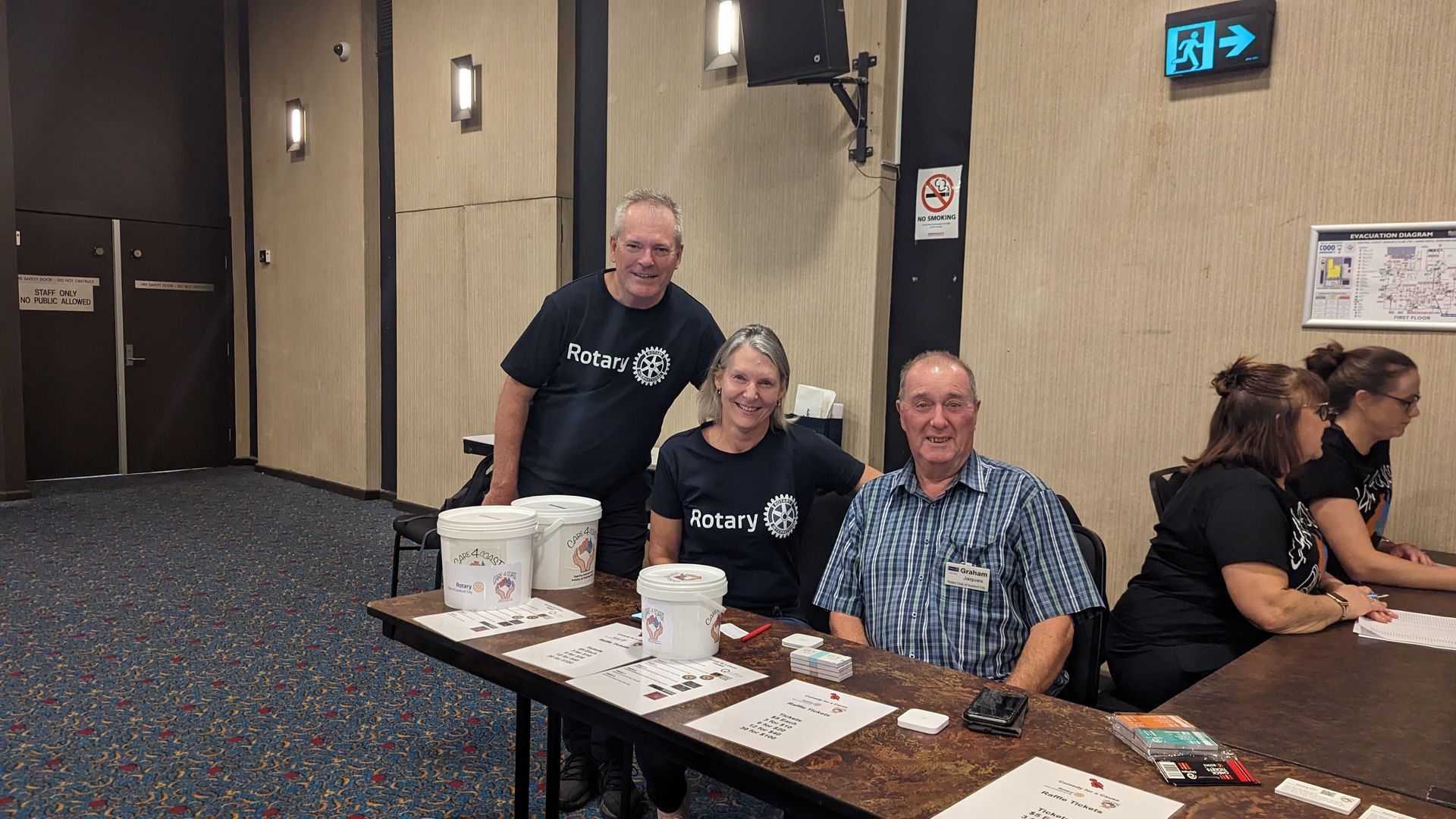 A group of people are sitting at a table in a room.