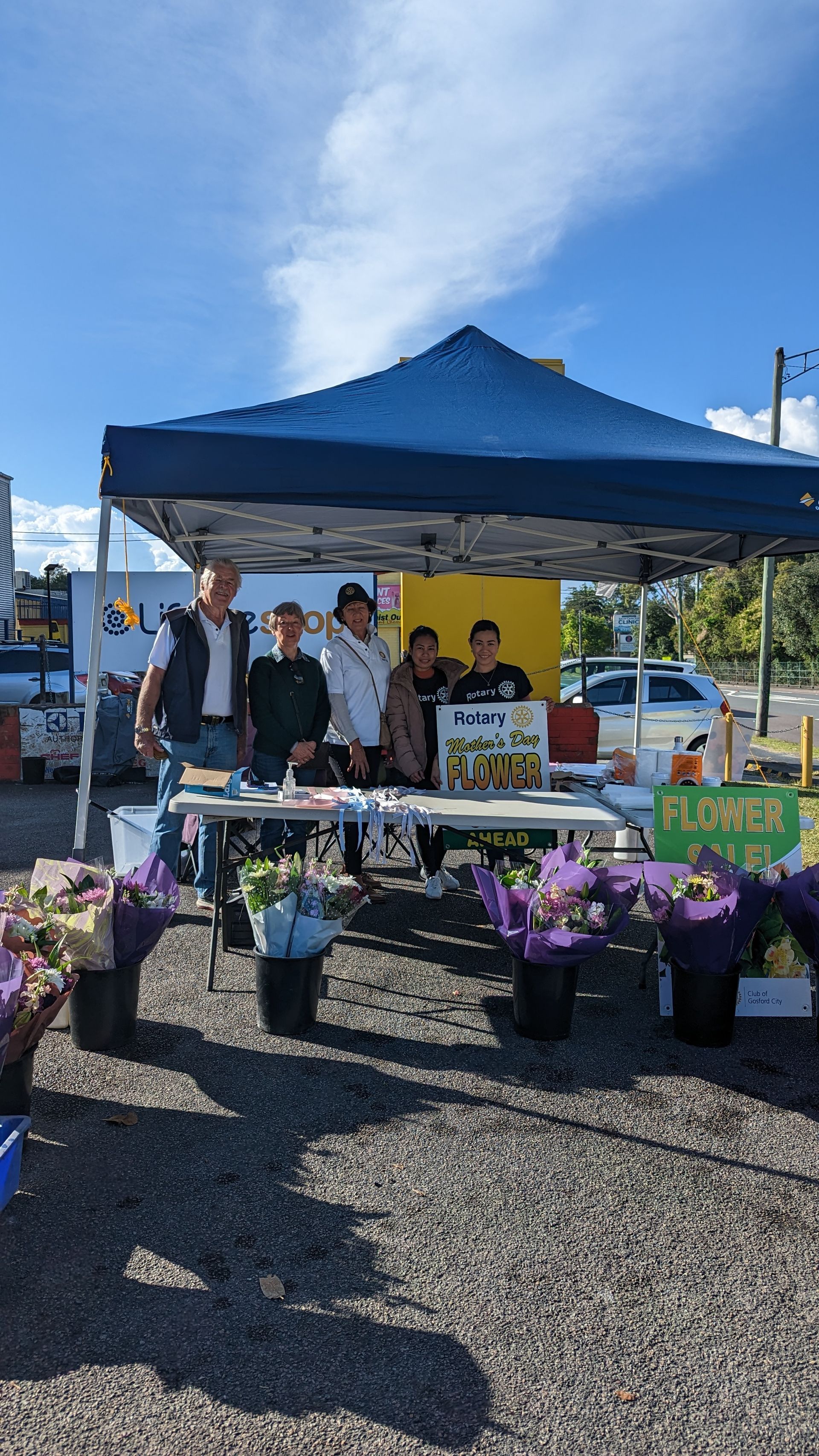 A group of people are standing in front of a tent.