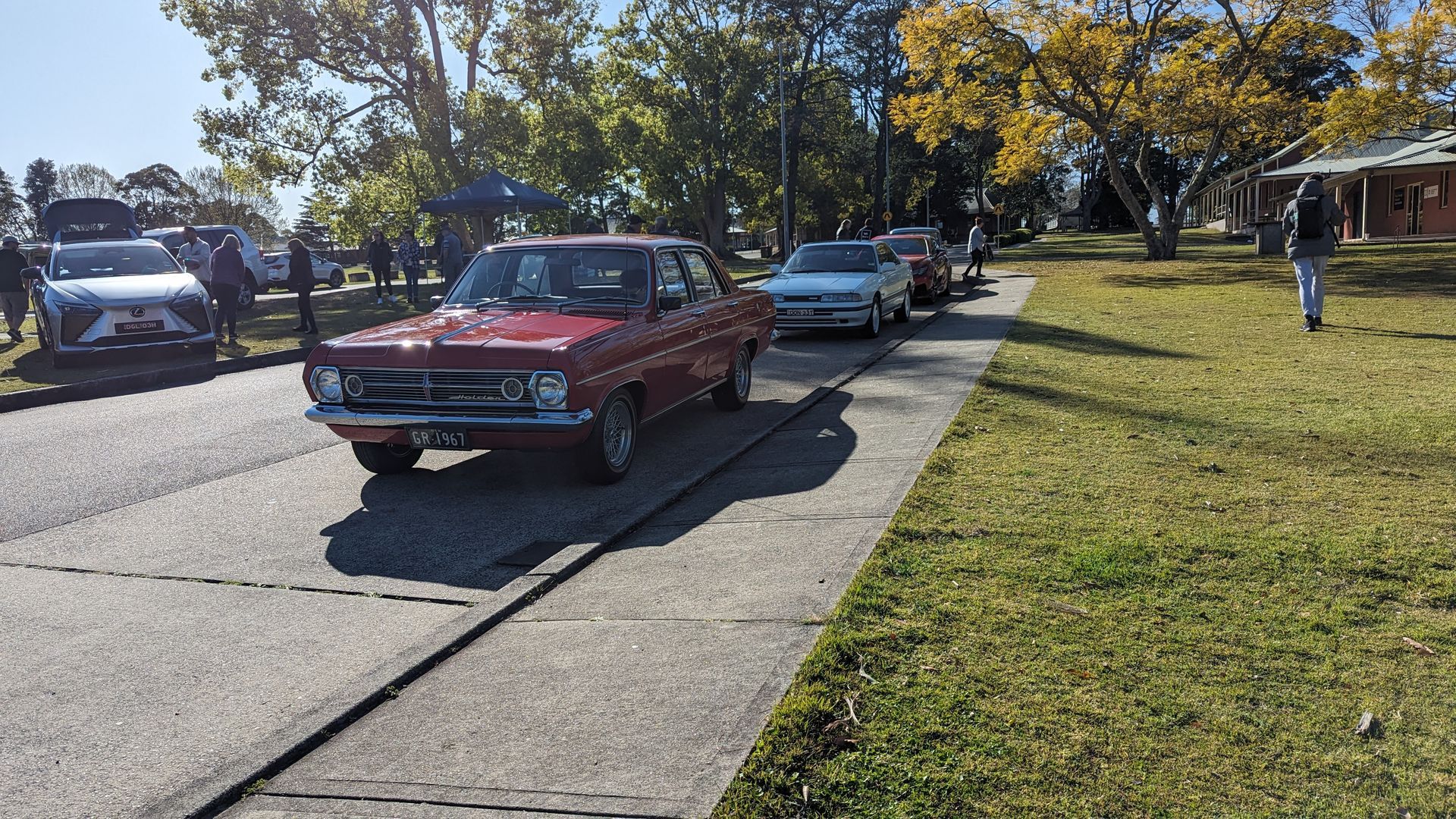 A group of cars are parked on the side of the road.