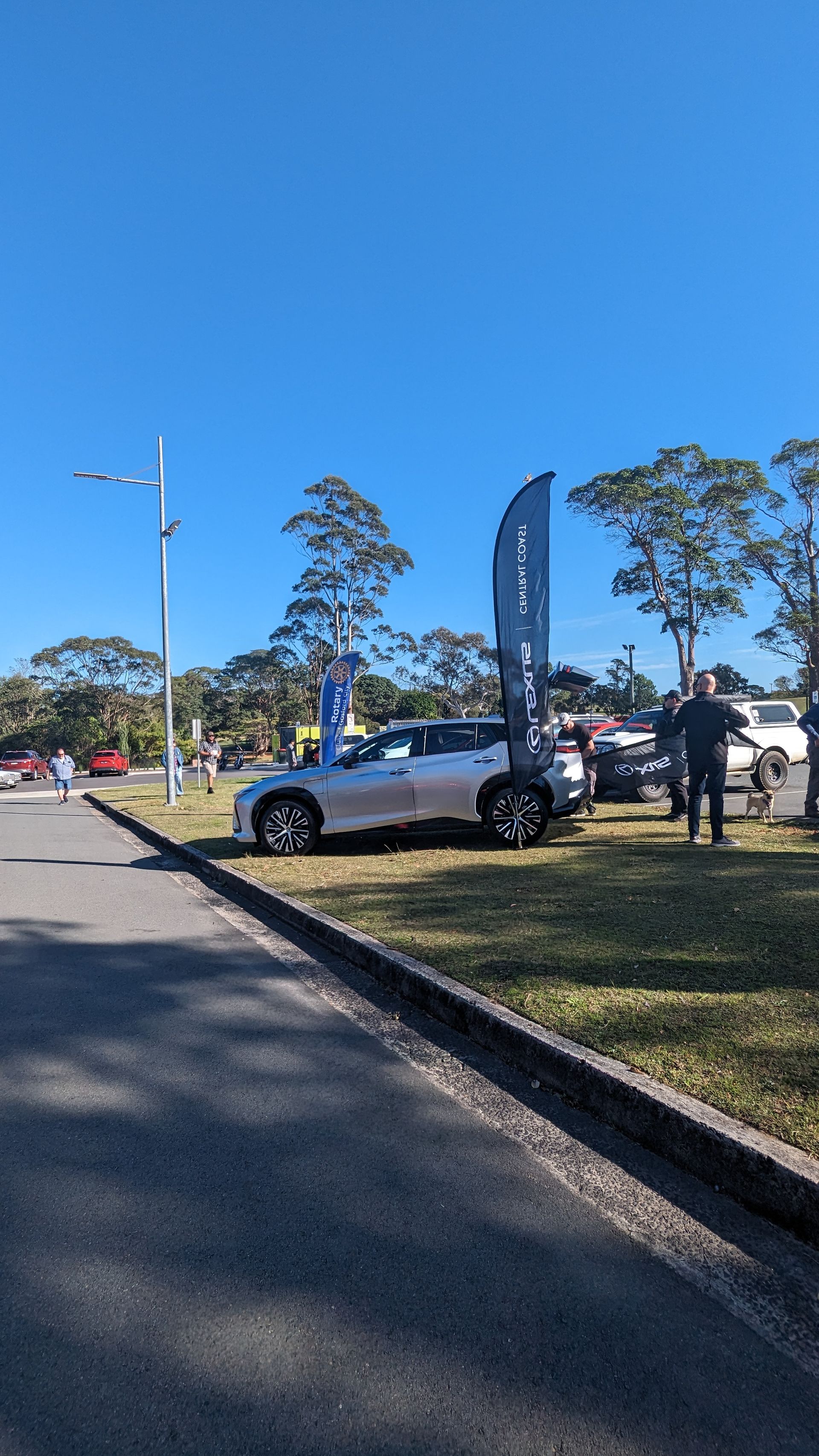A car is parked on the side of the road in a parking lot.