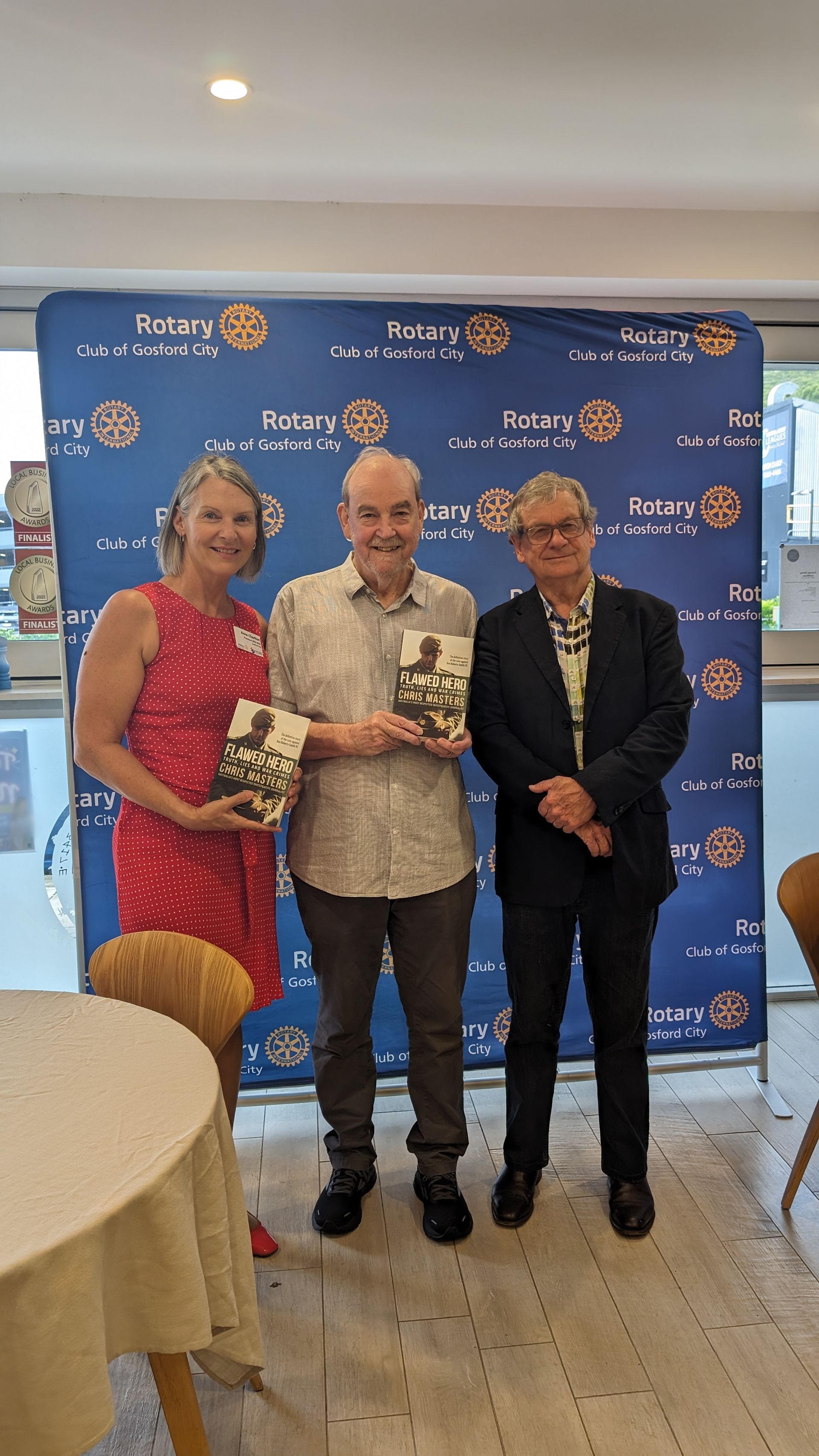 A group of people are standing next to each other in a room.