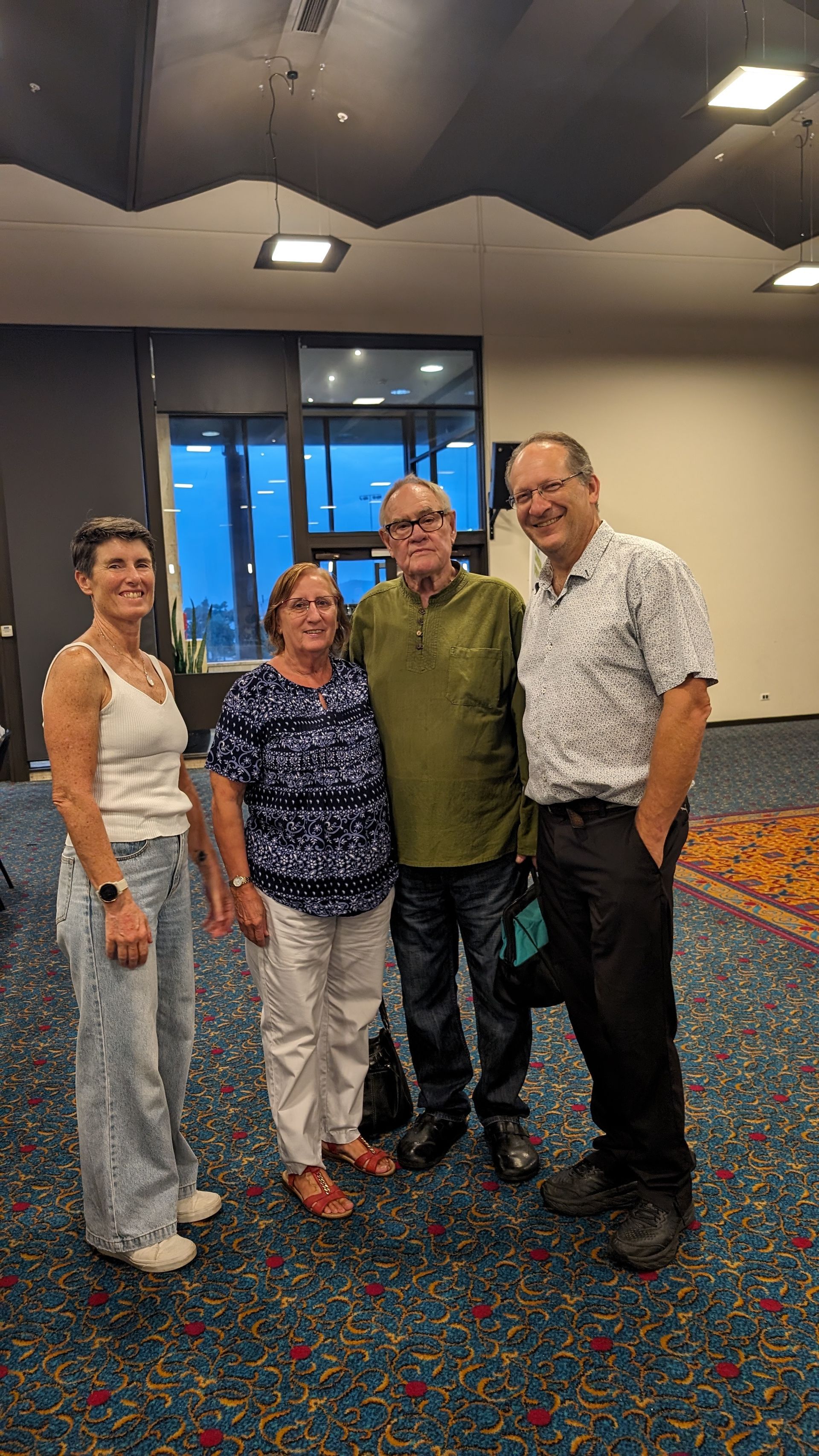 A group of people are posing for a picture in a room.
