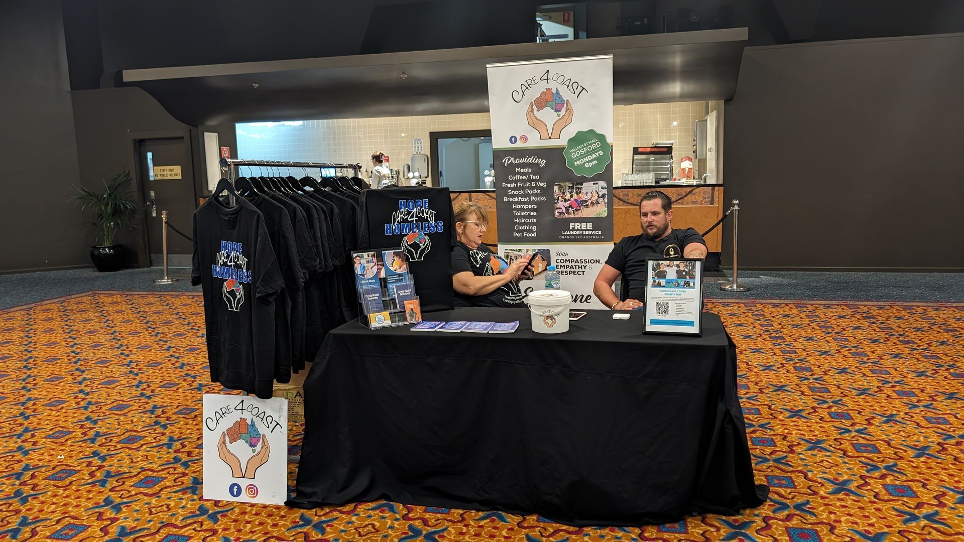 Two men are sitting at a table in a room.