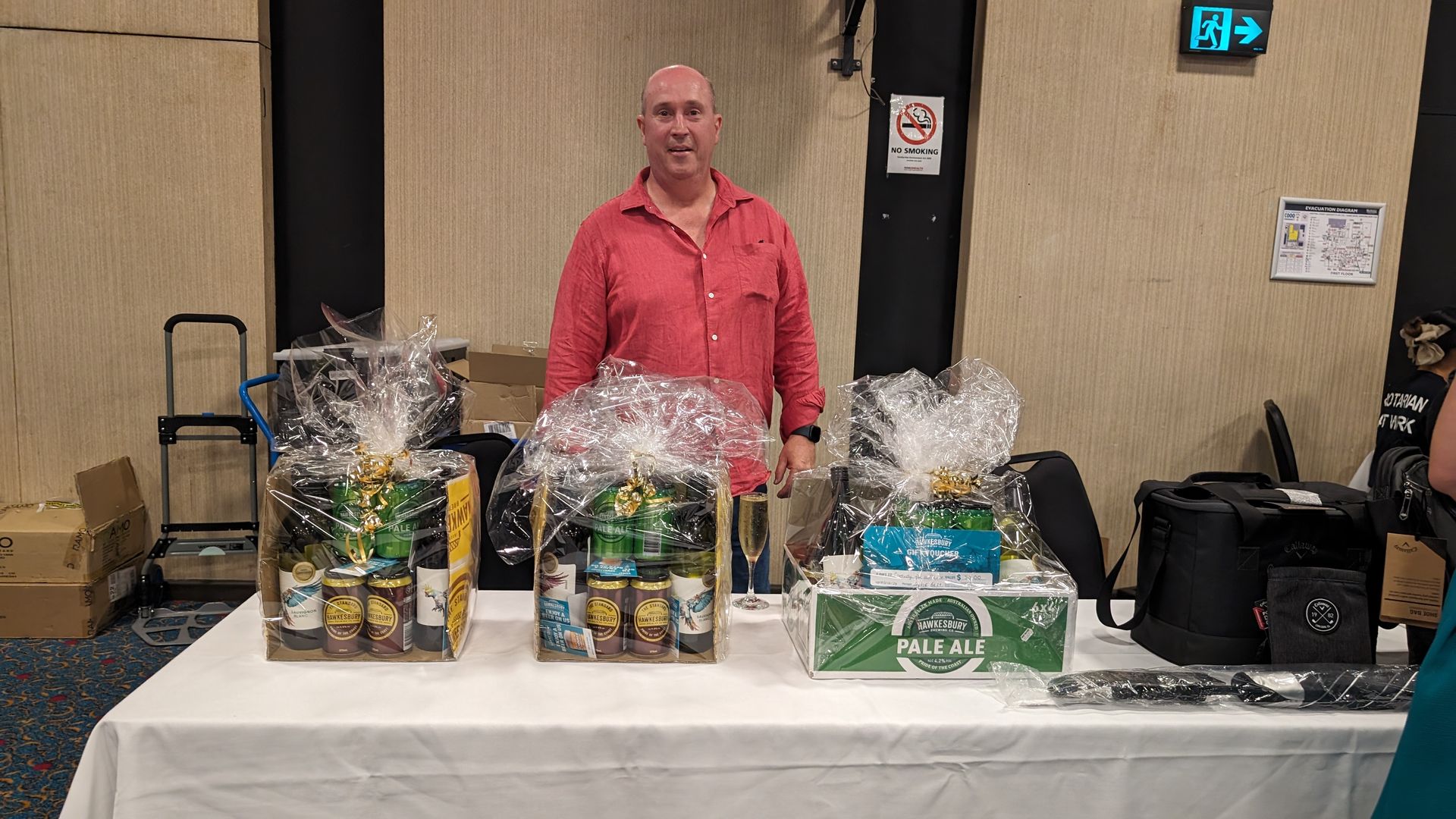 A man is standing in front of a table with three baskets on it.
