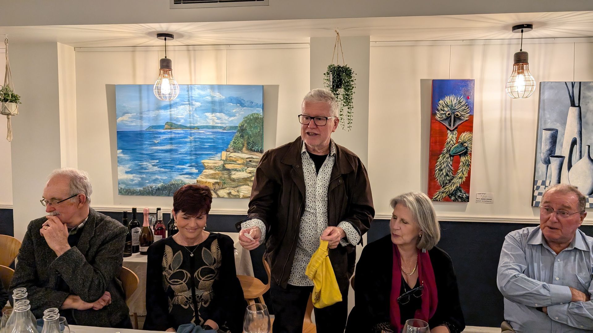 A group of people are sitting at a table in a restaurant.
