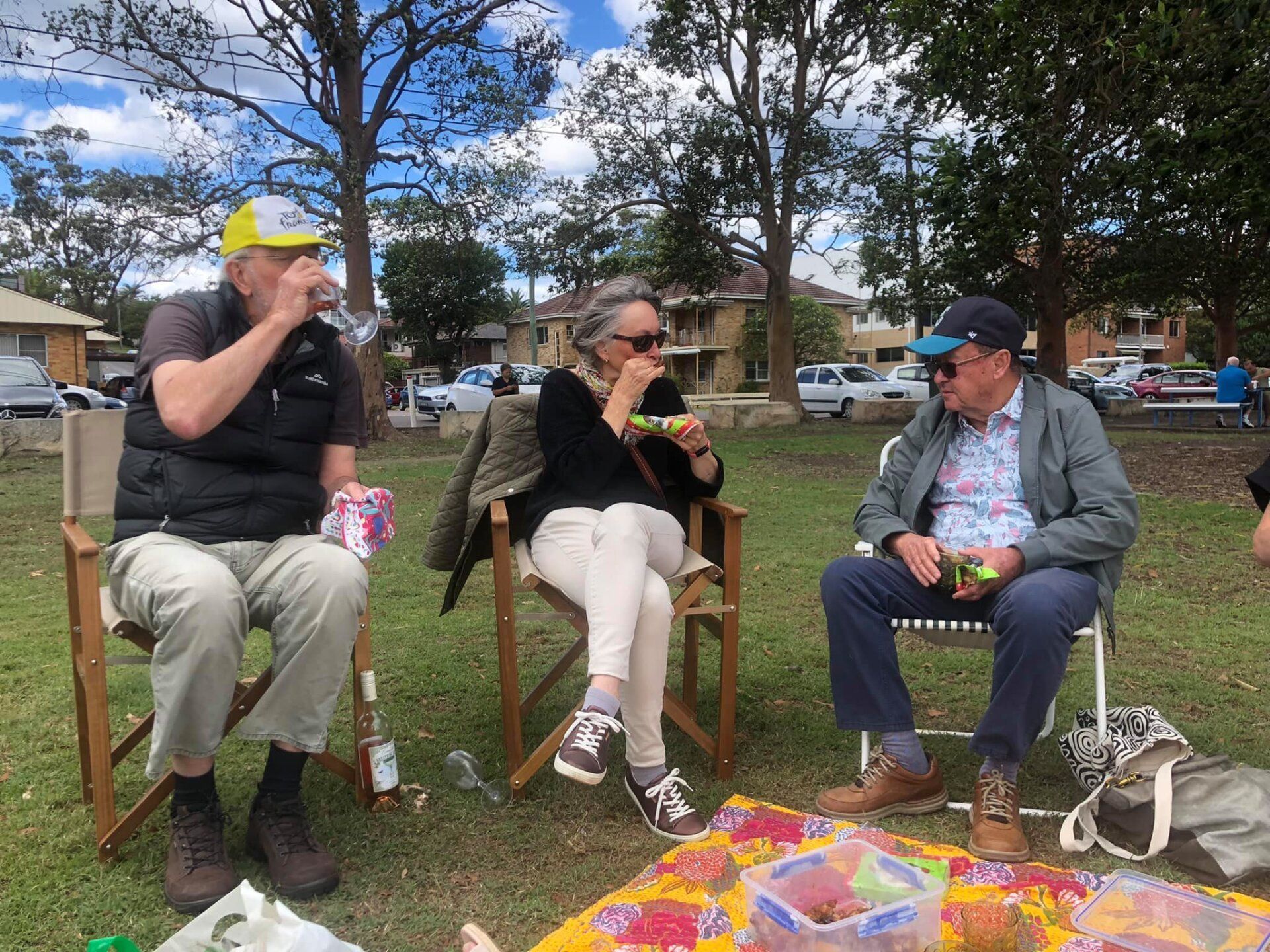 A group of people are having a picnic in a park.