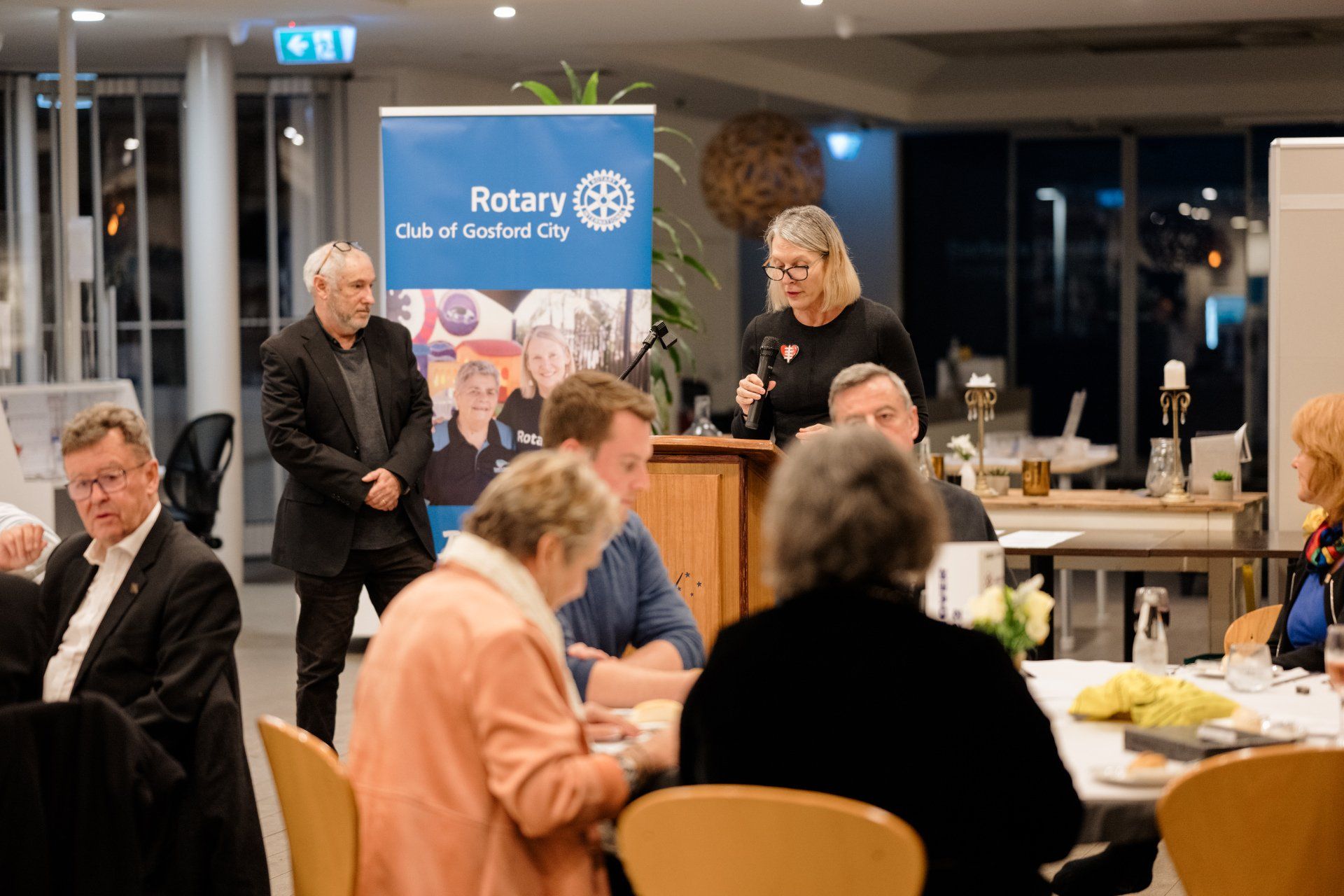 A group of people are sitting at tables in a room.