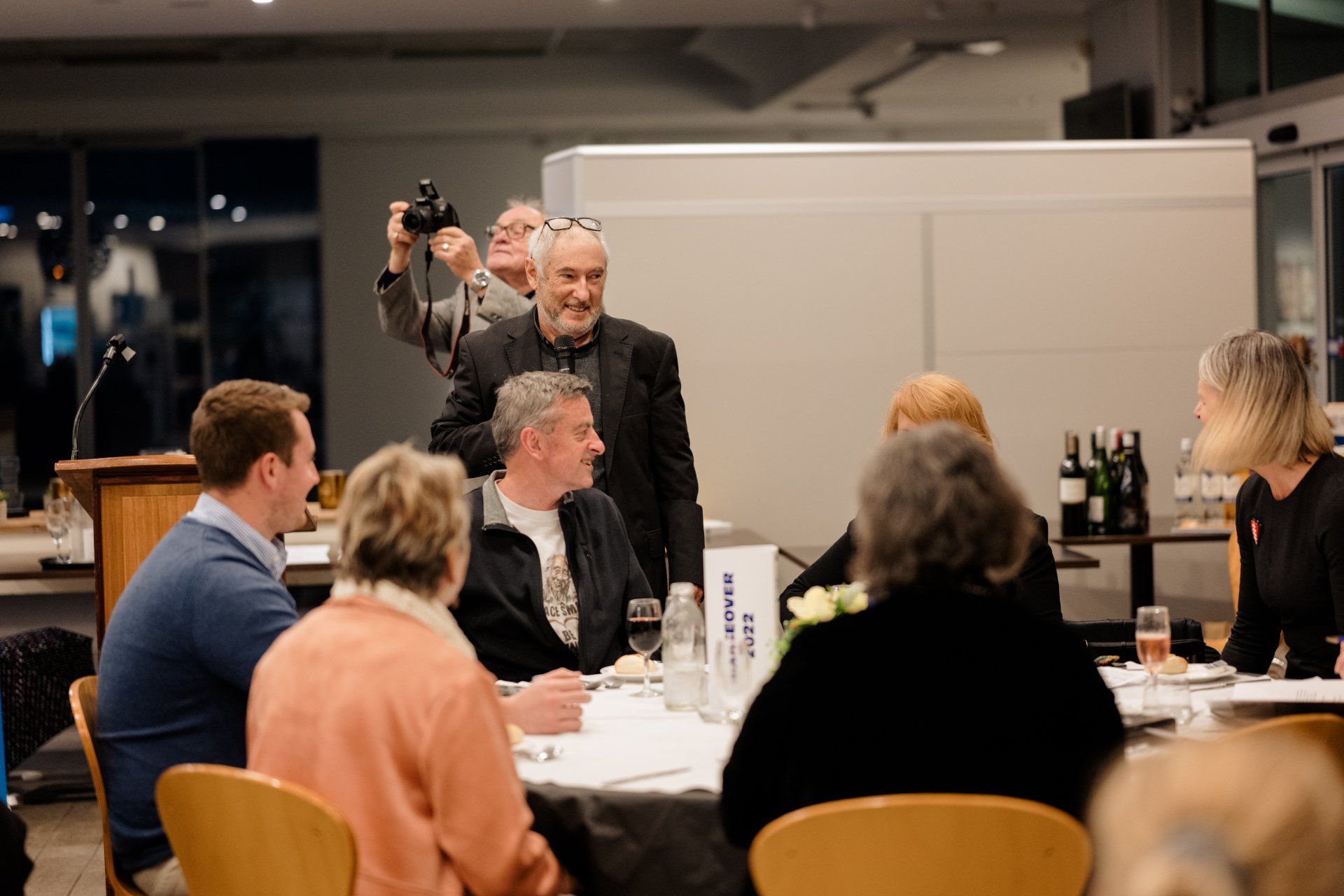 A group of people are sitting around a table in a room.