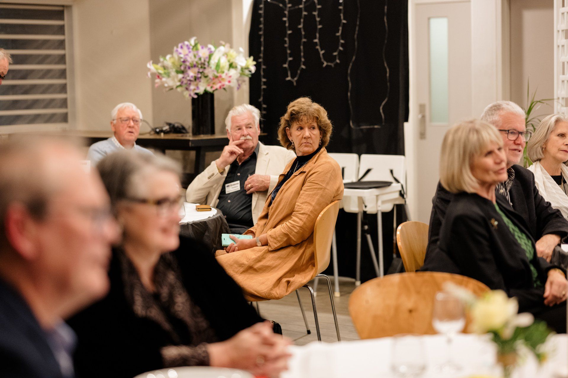A group of people are sitting at a table in a room.