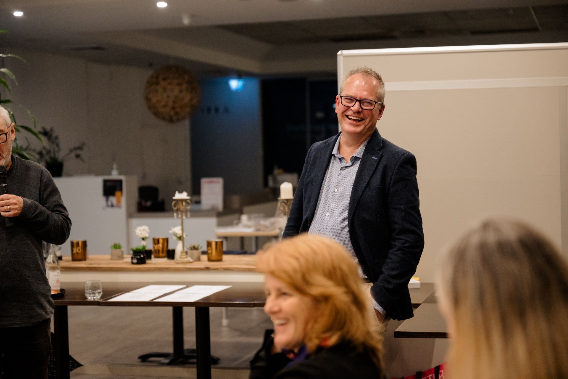 A group of people are standing around a table in a room.