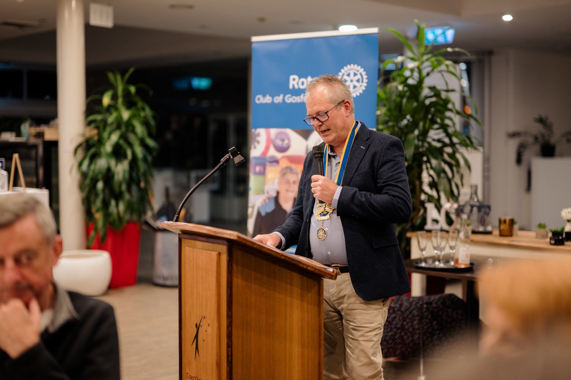A man is standing at a podium giving a speech.