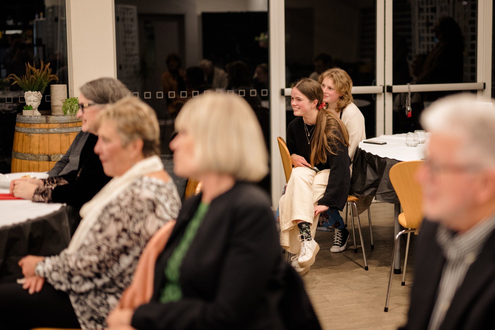 A group of people are sitting at tables in a room.