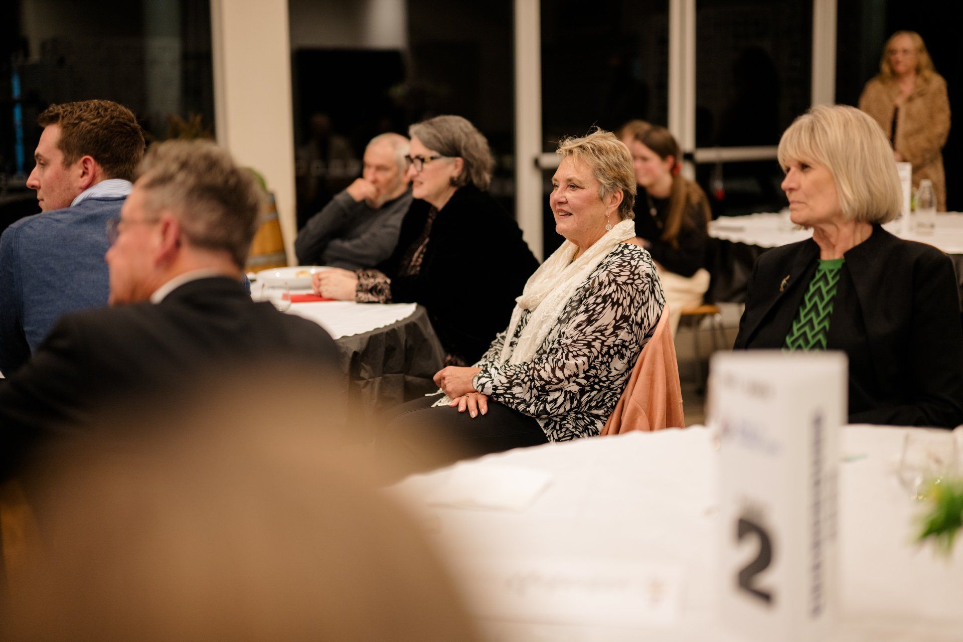 A group of people are sitting at tables in a room.