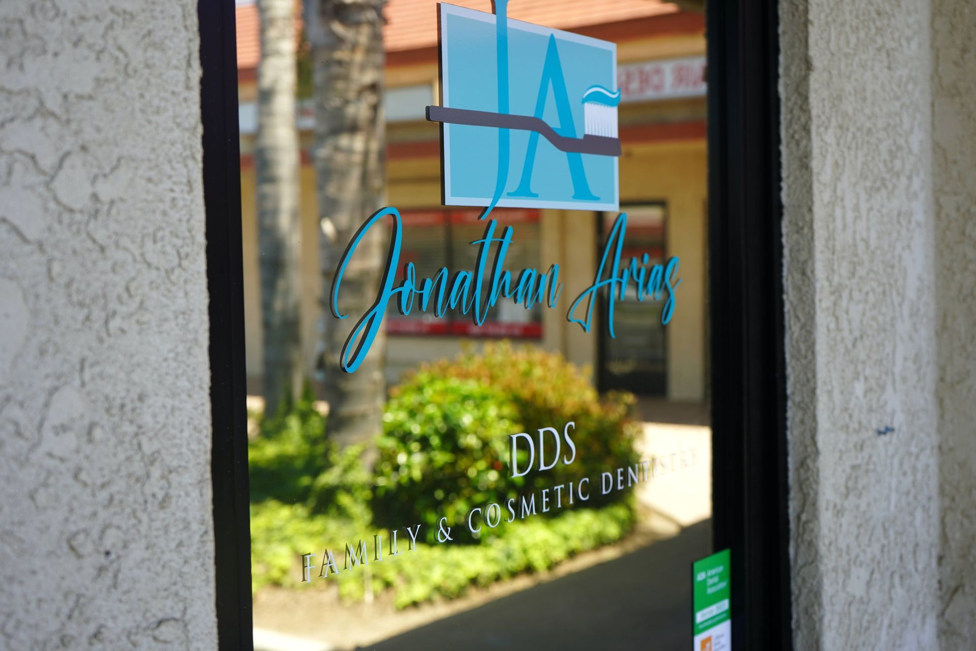 Jonathan Arias DDS logo in front door