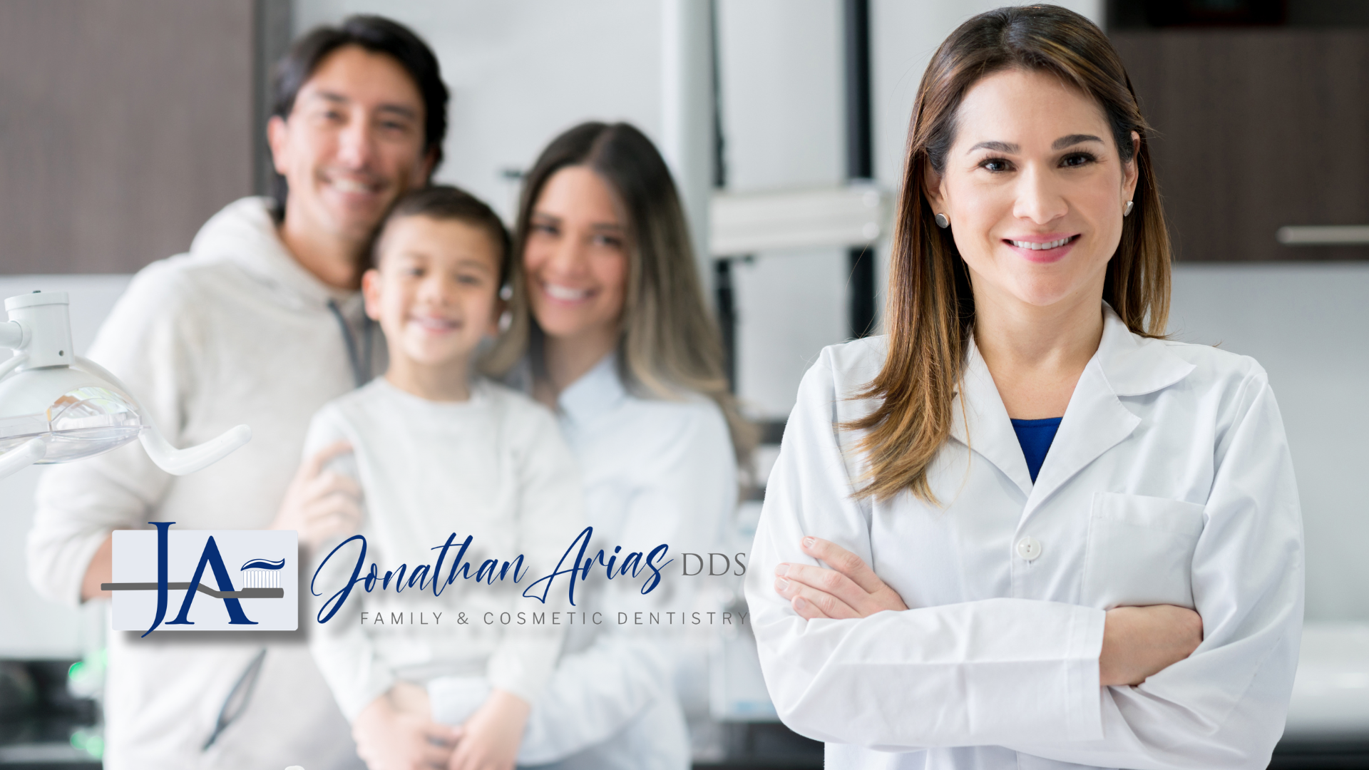A dentist is posing for a picture with a family in the background.