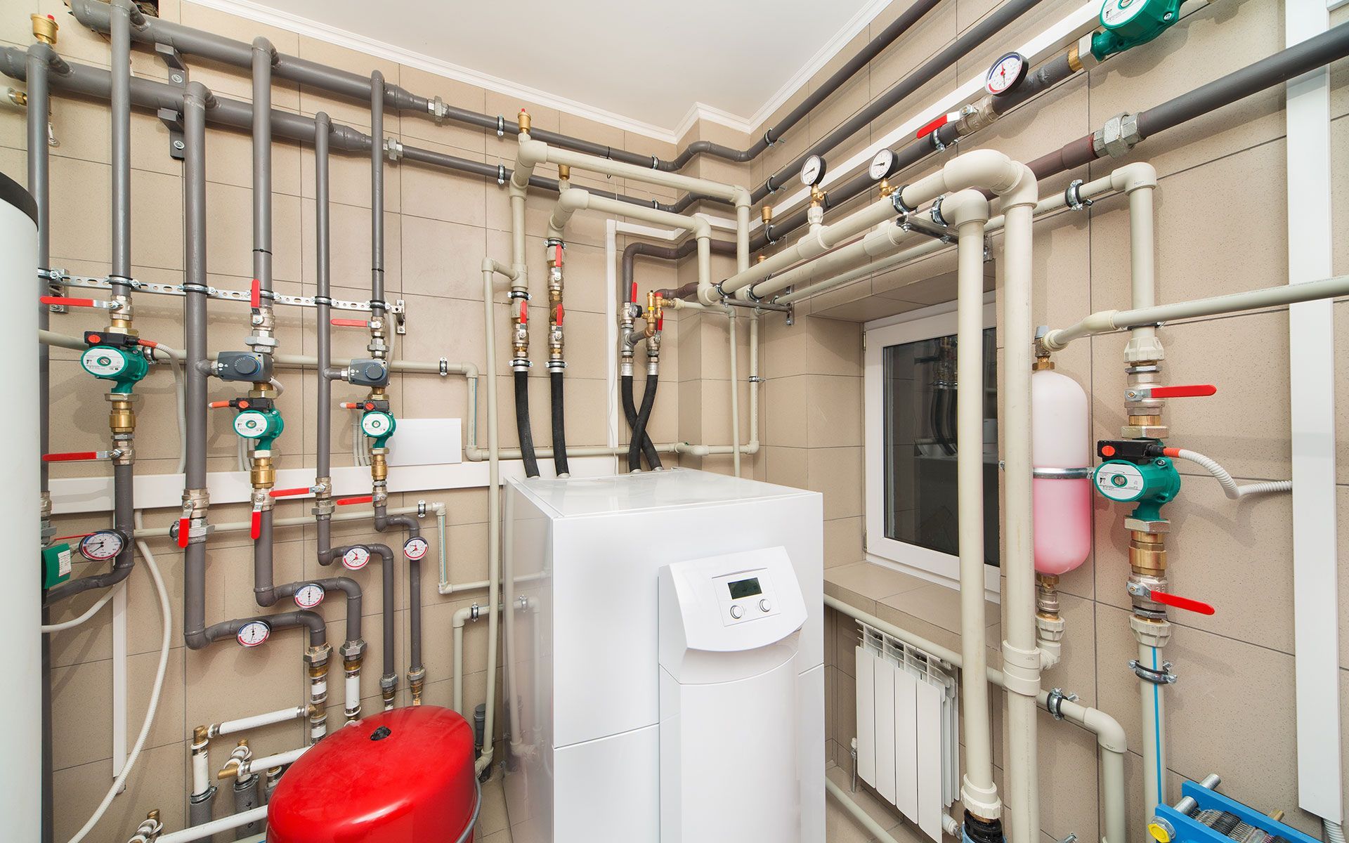 A room filled with lots of pipes and a heater.