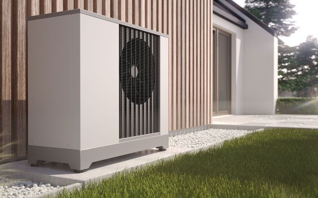 An air conditioner is sitting outside of a house.