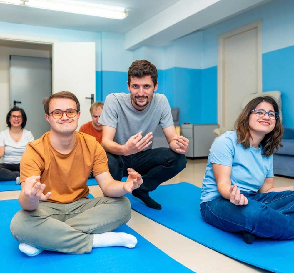 A Group of People Are Sitting on Yoga Mats in A Room — Active Ables Community Services In Tamworth, NSW