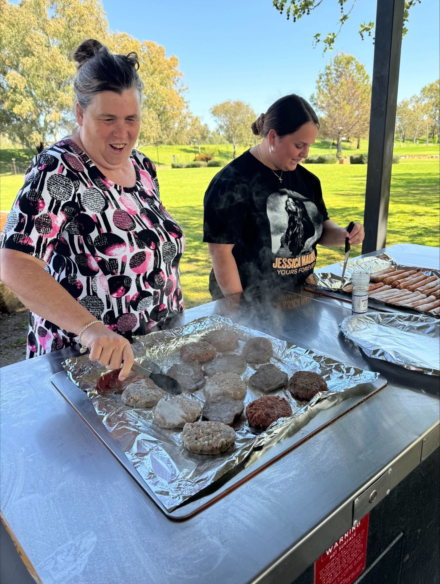 A Woman Is Holding A Teddy Bear In Her Arms While A Little Girl Looks On — Active Ables Community Services In Tamworth, NSW