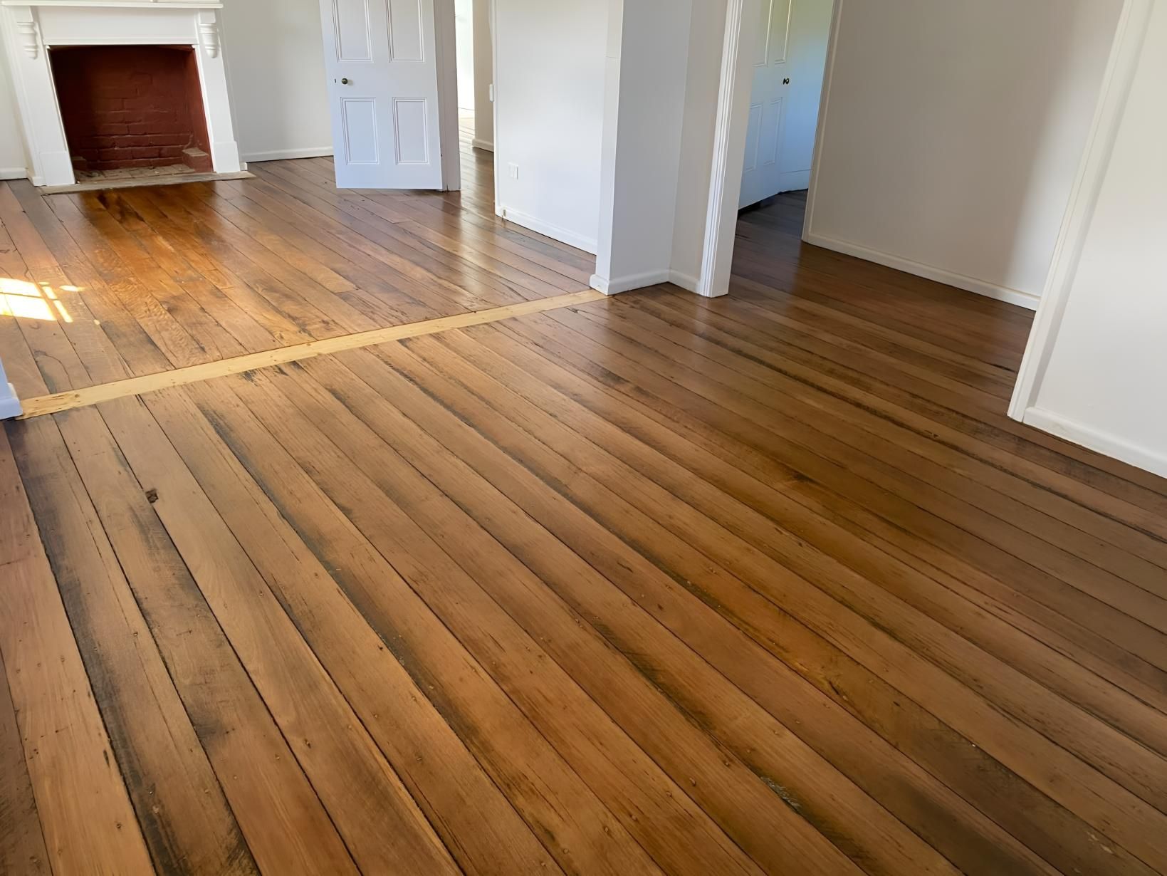 A Living Room With Hardwood Floors And A Fireplace — Coolangatta Floor Sanding In Shoalhaven Heads, NSW