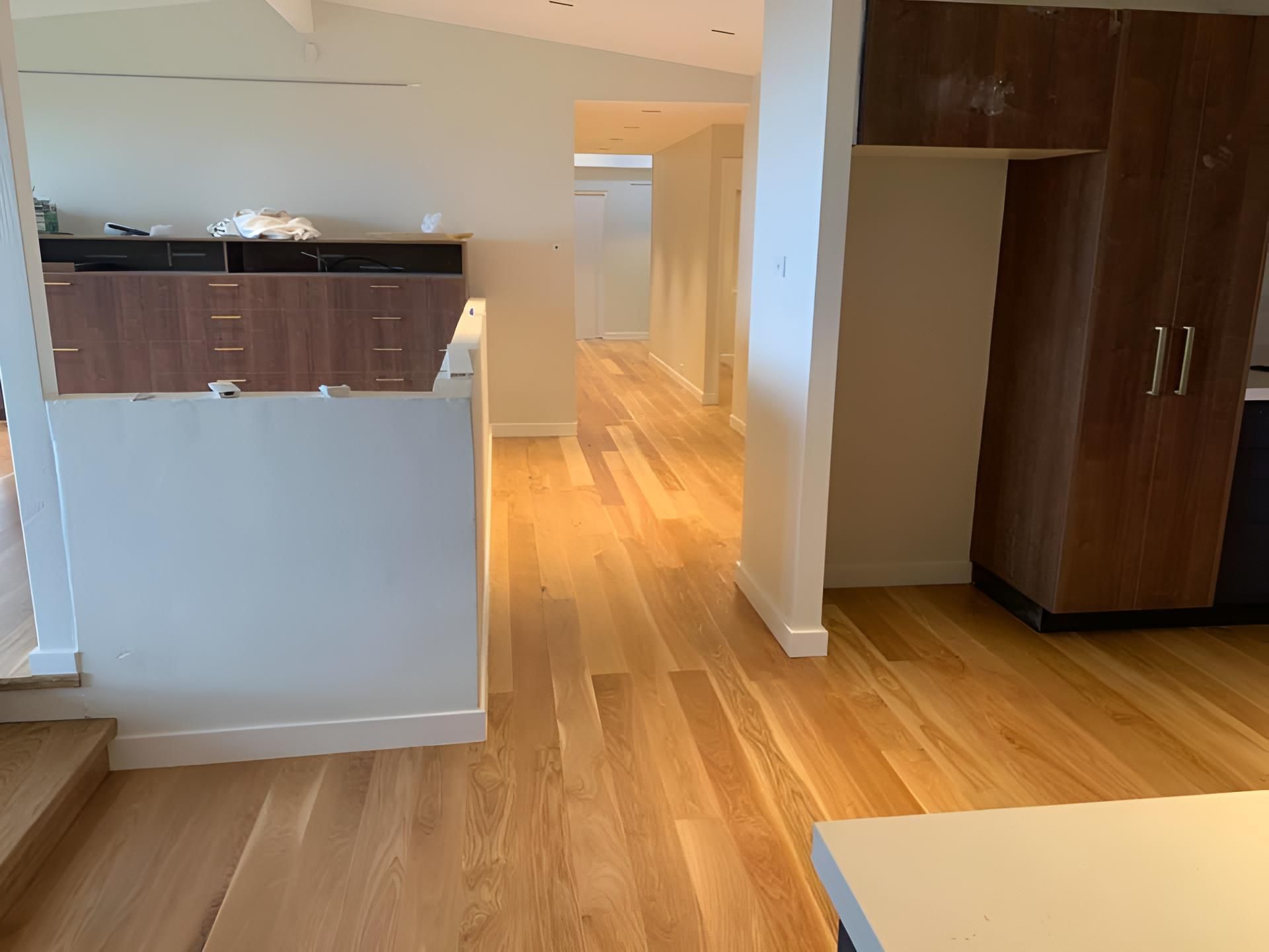 A Kitchen With Hardwood Floors And White Walls — Coolangatta Floor Sanding In Nowra, NSW
