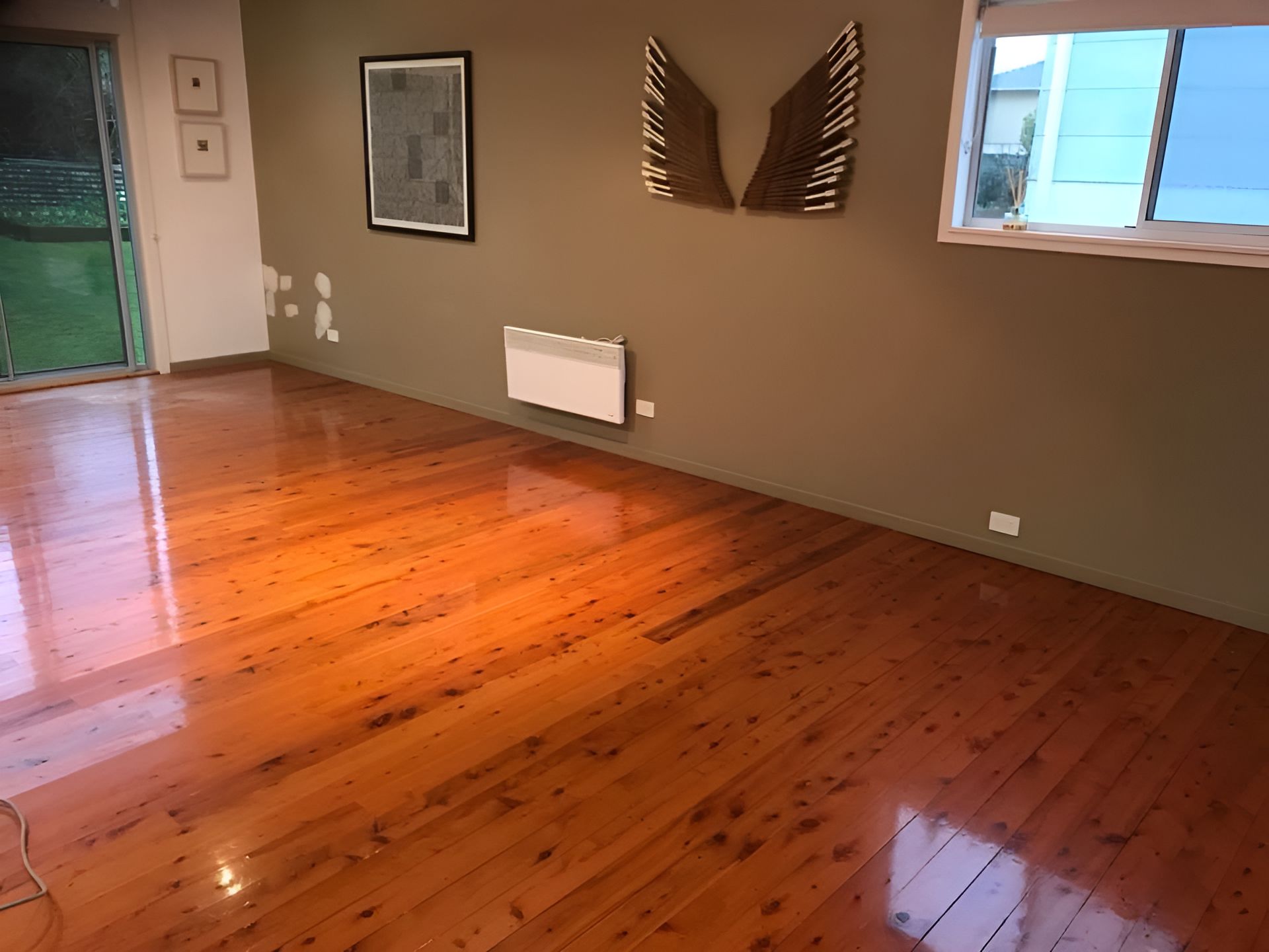 A Living Room With A Wooden Floor And A Window — Coolangatta Floor Sanding In Shoalhaven Heads, NSW
