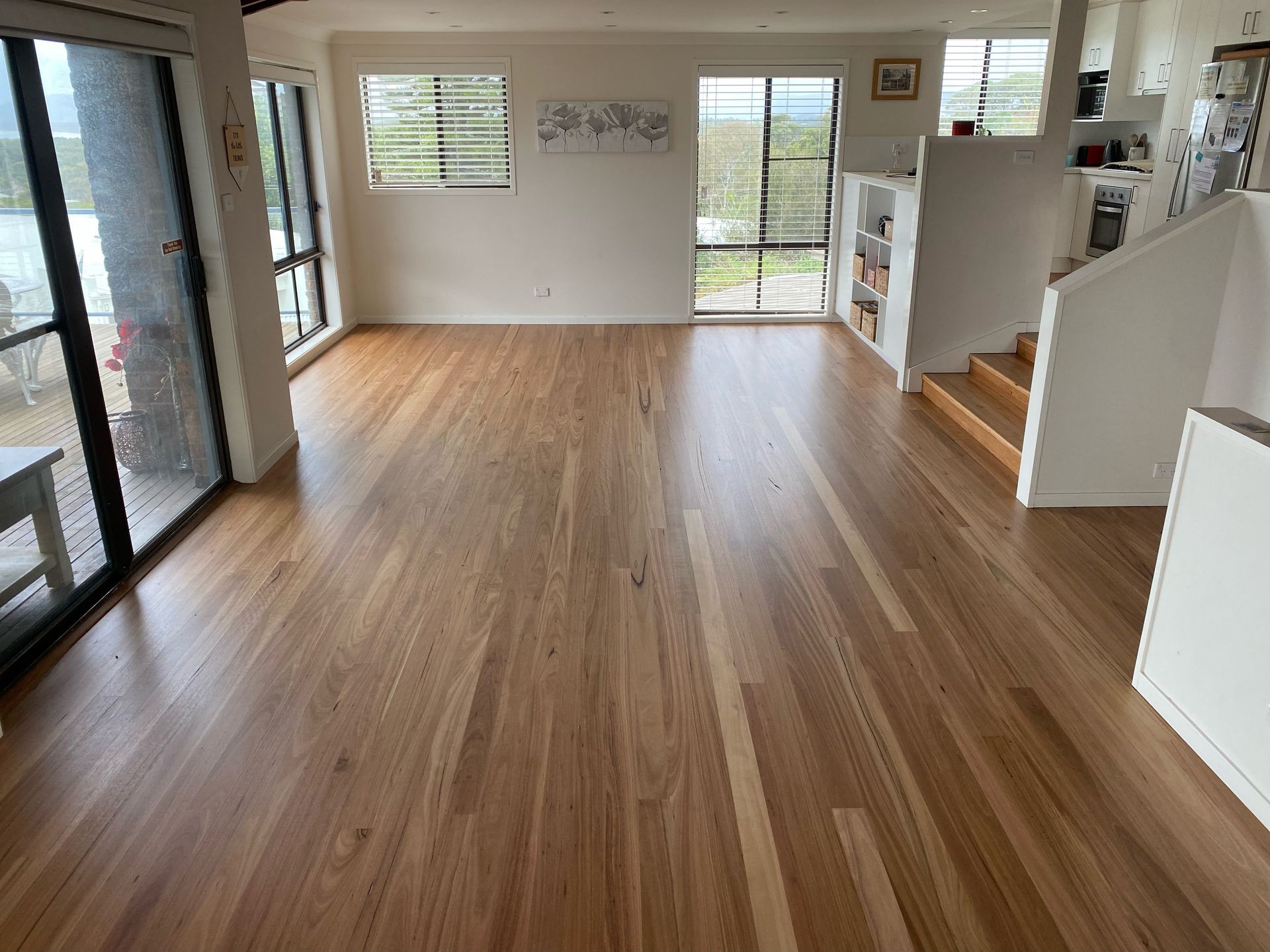 A living room with hardwood floors and stairs — Coolangatta Floor Sanding In Shoalhaven Heads, NSW