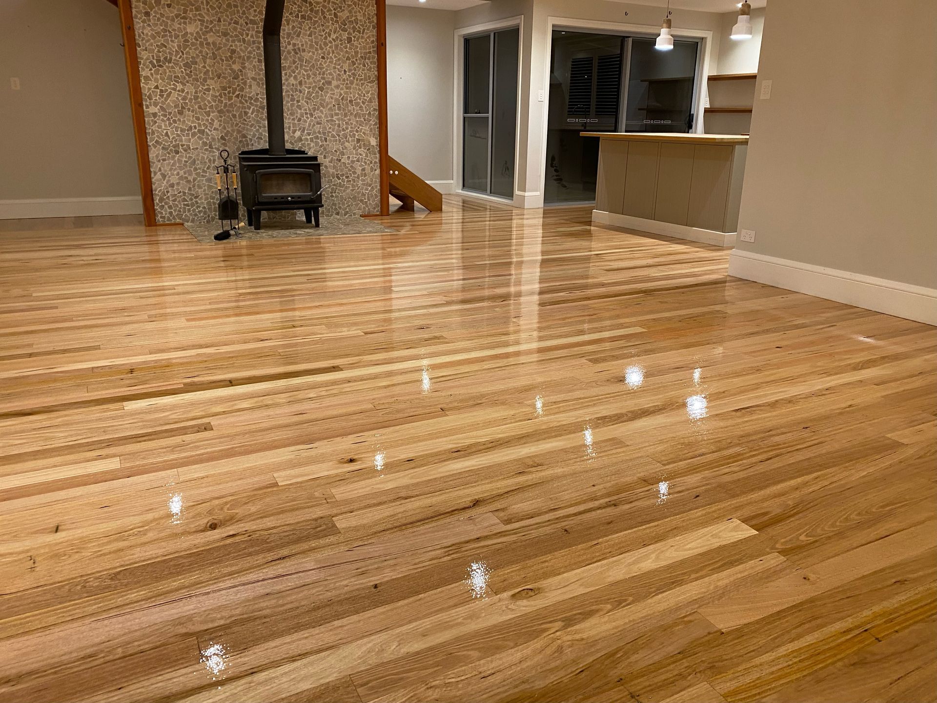 A living room with hardwood floors and a fireplace — Coolangatta Floor Sanding In Shoalhaven Heads, NSW