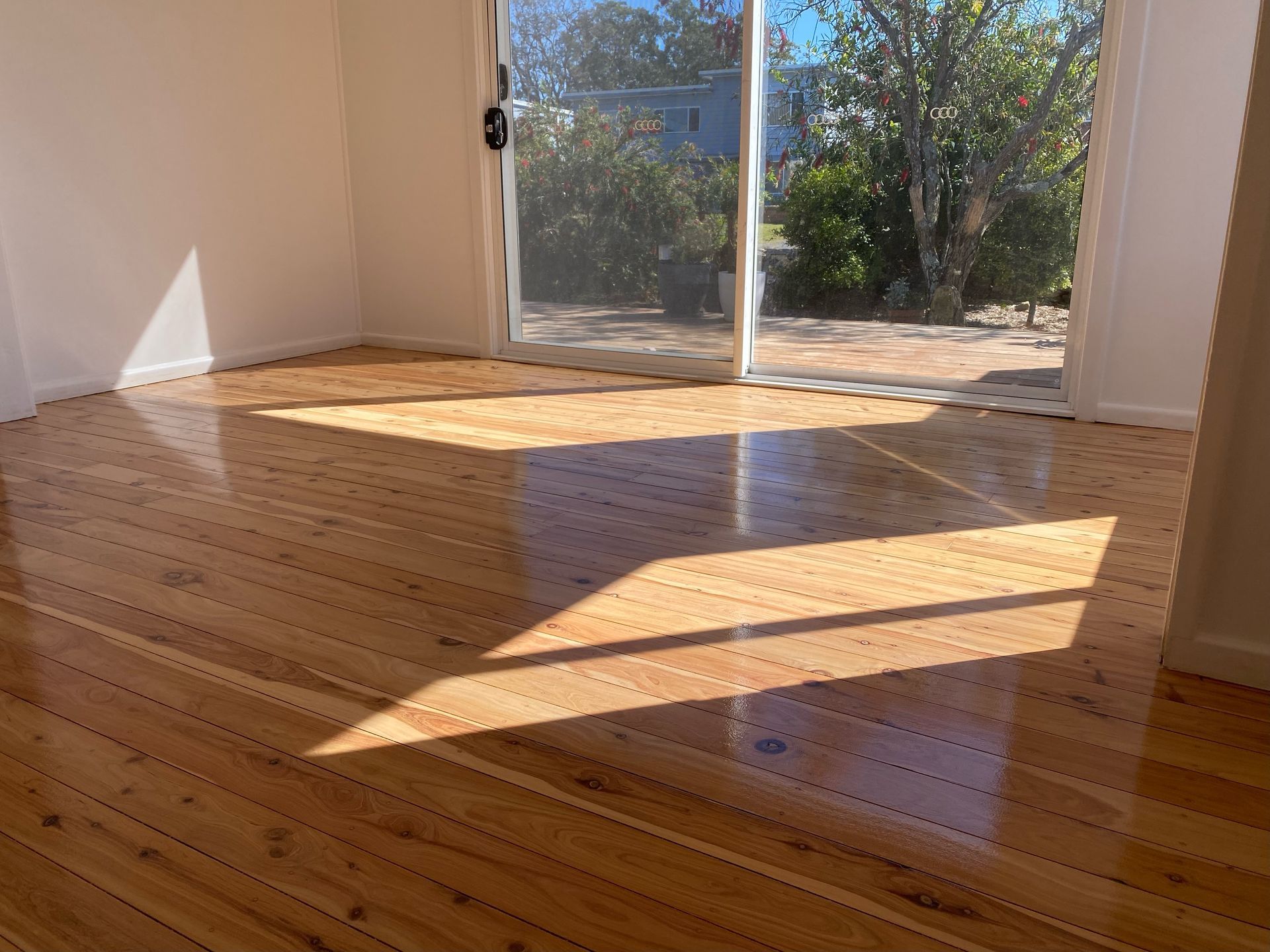 A room with a wooden floor and a sliding glass door — Coolangatta Floor Sanding In Shoalhaven Heads, NSW