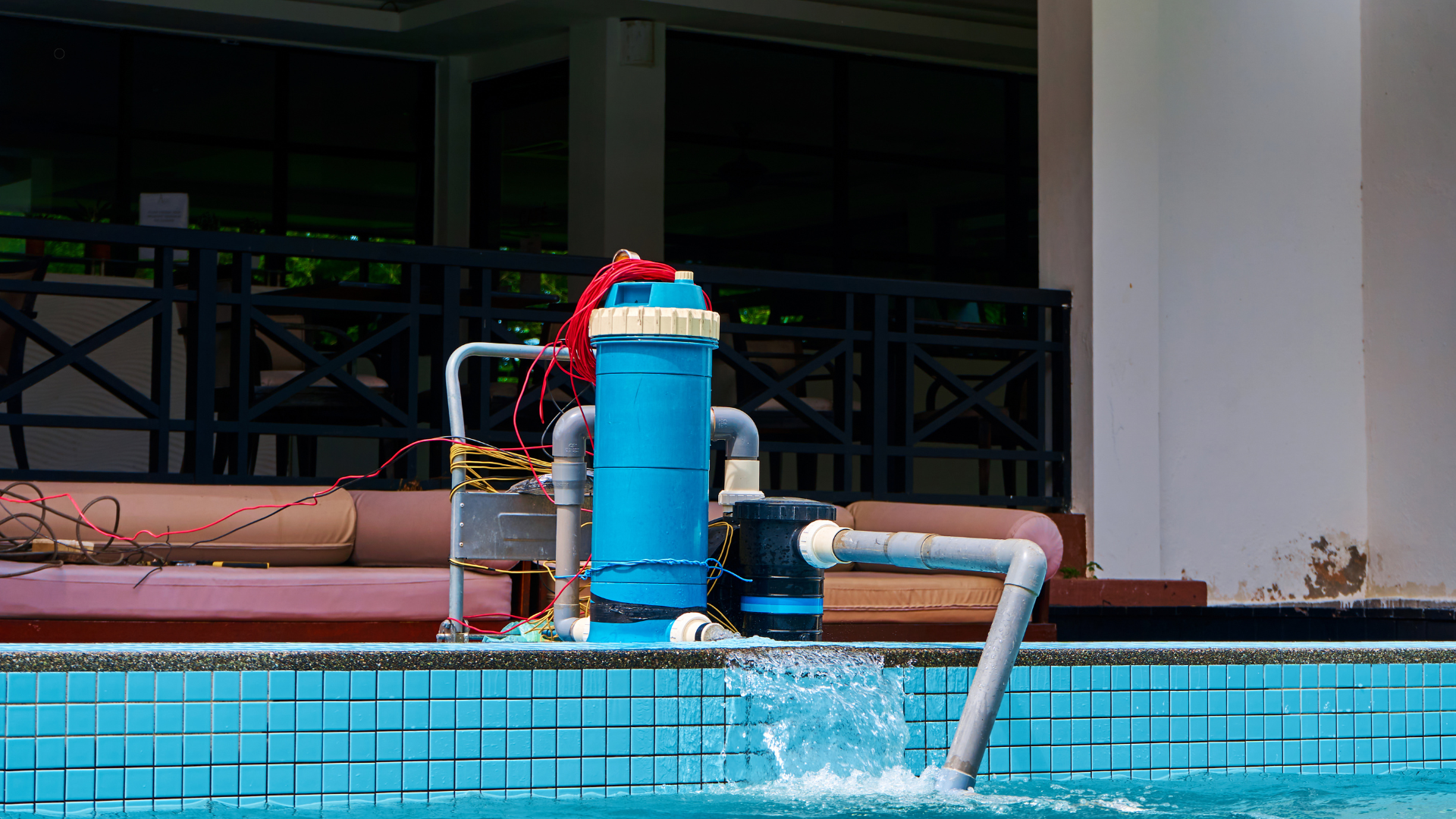Pool pump system with blue filter and hoses connected, circulating water to maintain clean pool conditions.