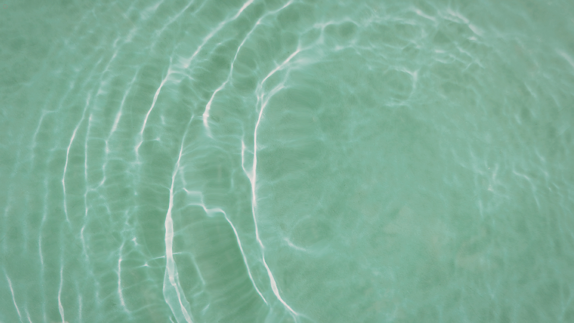 Close-up of clear pool water with gentle ripples, showcasing the tranquility and beauty of a well-ma