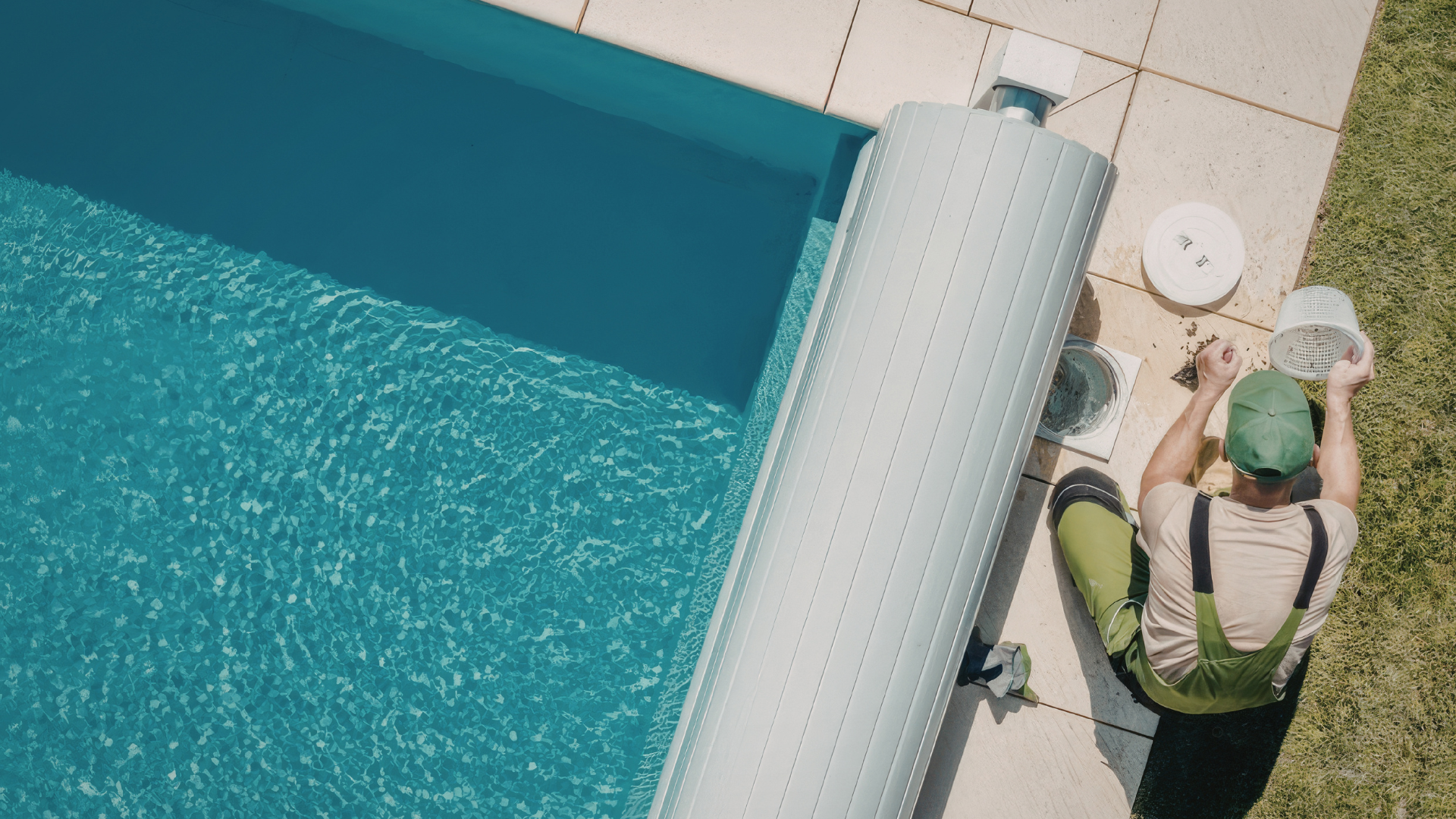 Pool technician performing maintenance near the edge of a swimming pool, cleaning the filter to ensure optimal pool performance and water clarity.