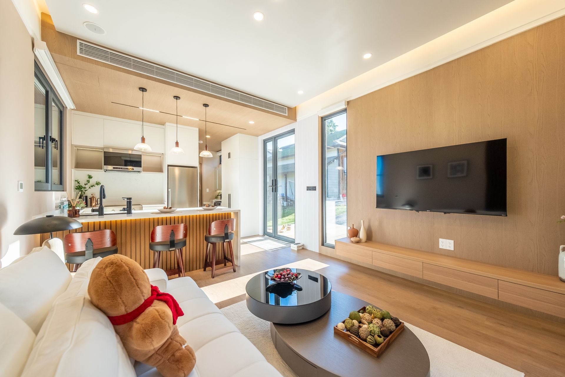 A living room with wooden shelves and a flat screen tv