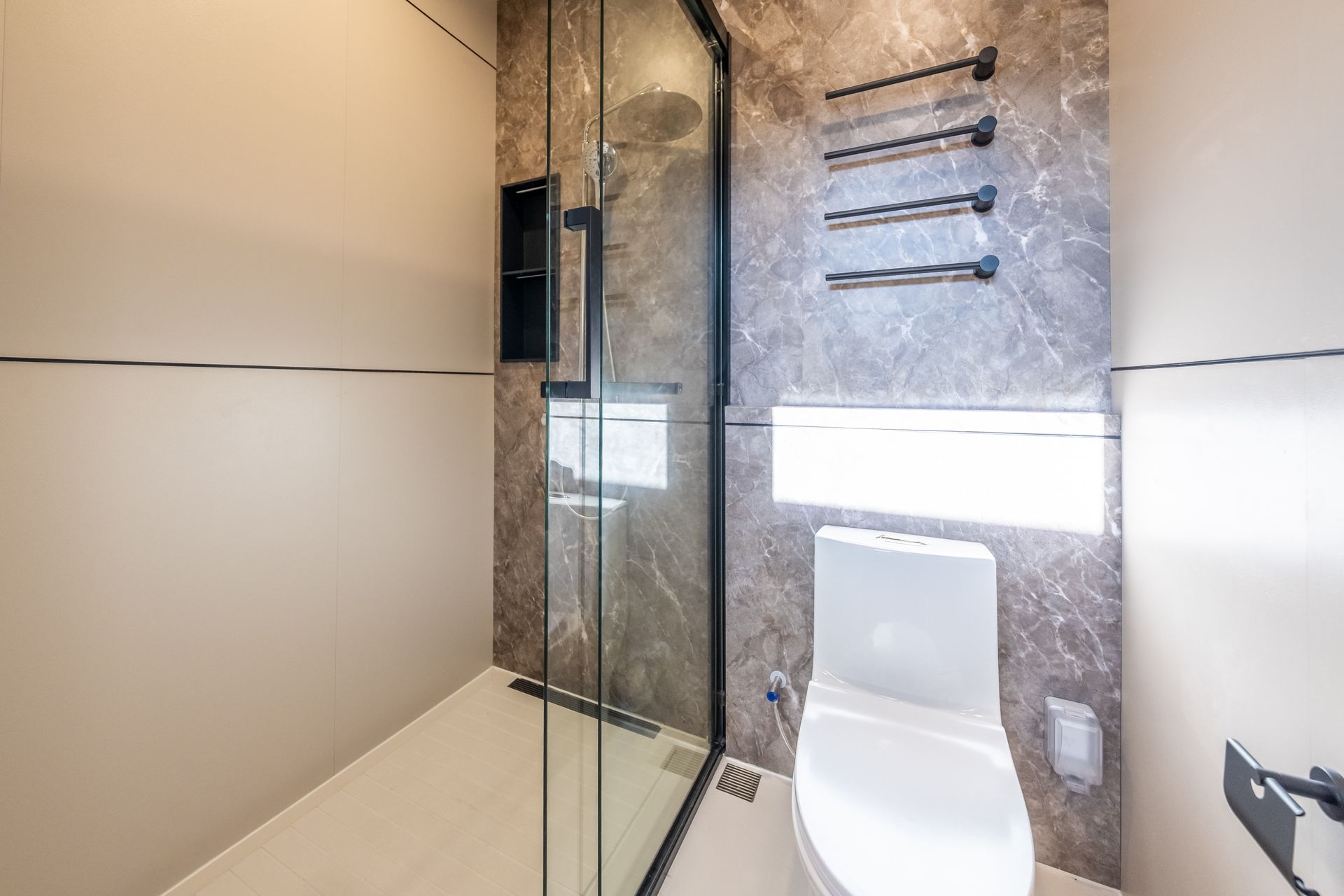 A living room with wooden shelves and a flat screen tv