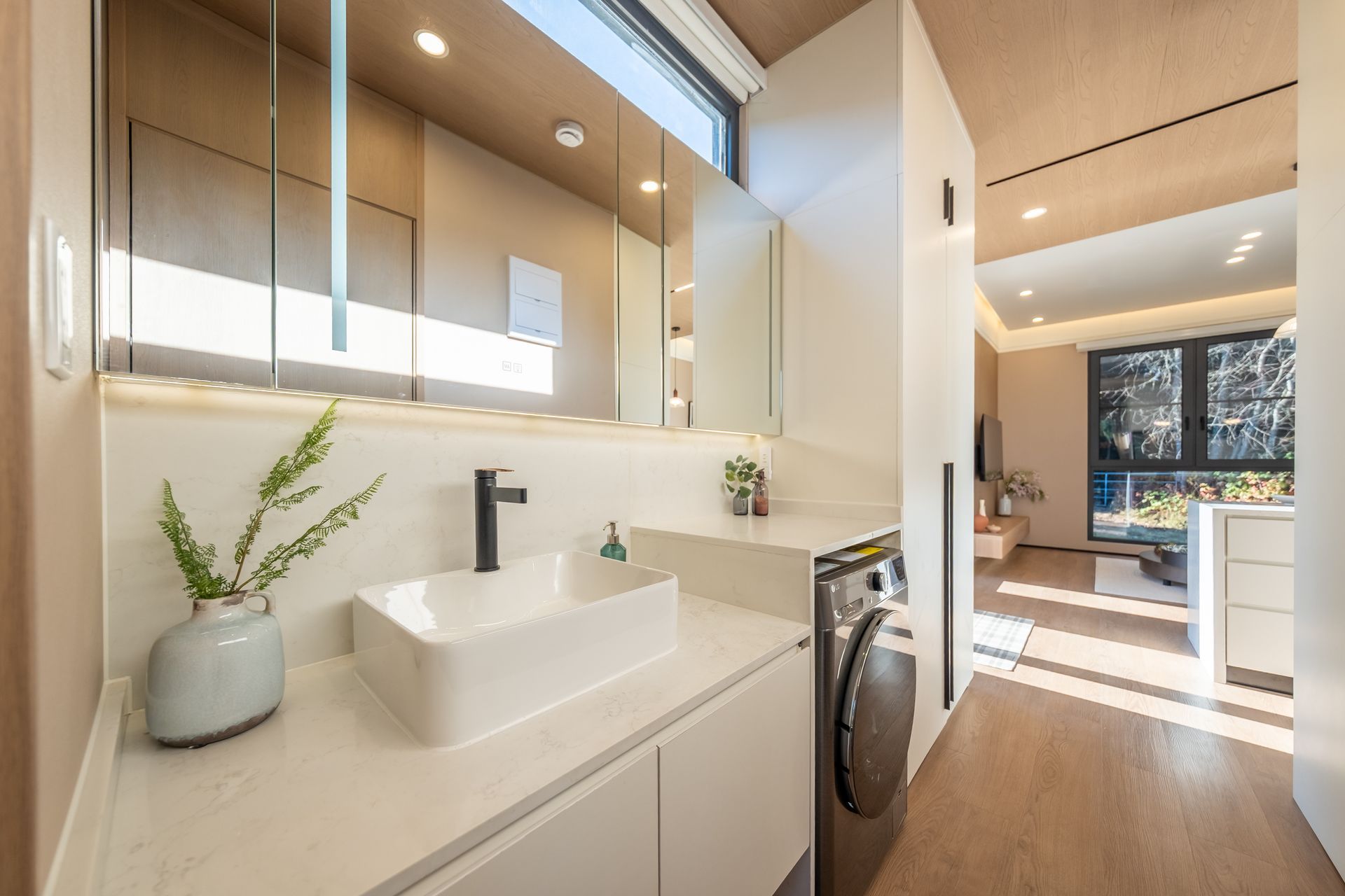 A living room with wooden shelves and a flat screen tv