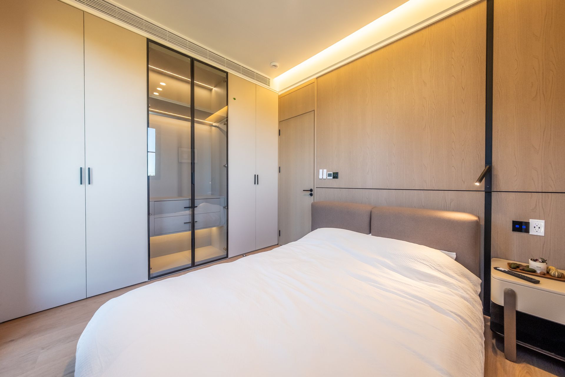 A living room with wooden shelves and a flat screen tv