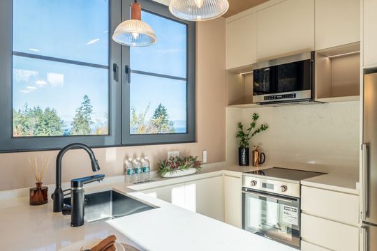 A house with a deck and chairs in front of it