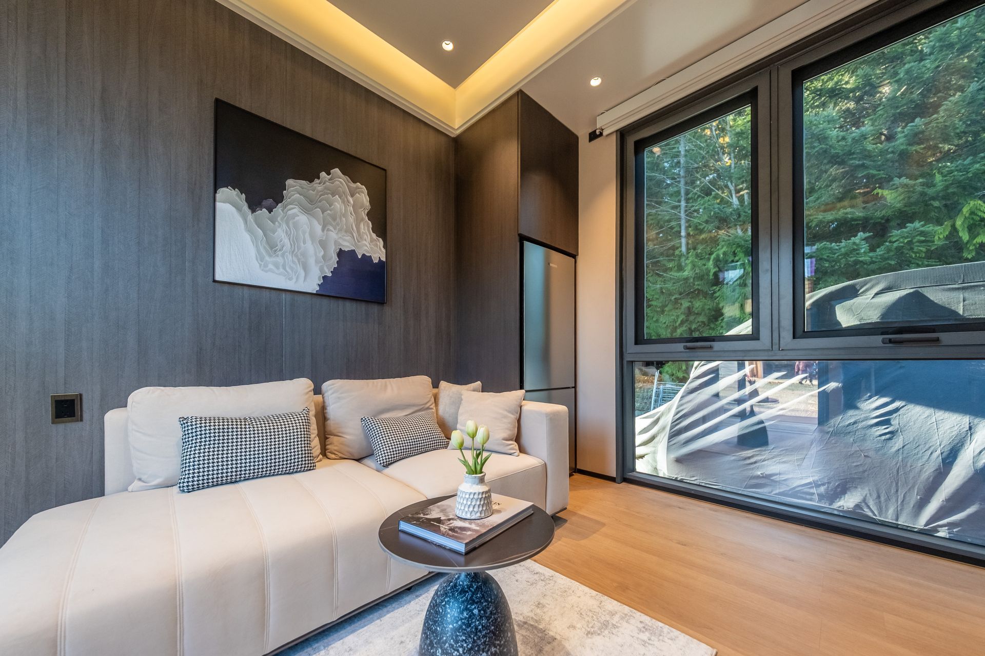 A living room with wooden shelves and a flat screen tv