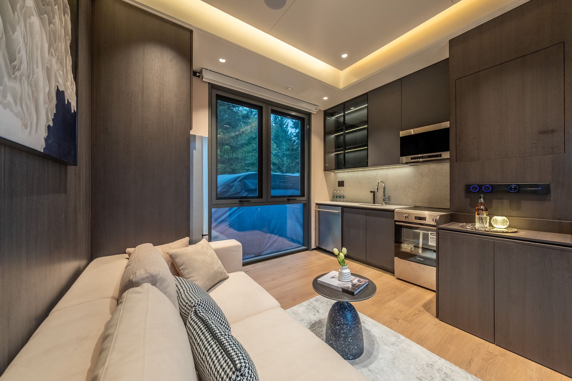A living room with wooden shelves and a flat screen tv