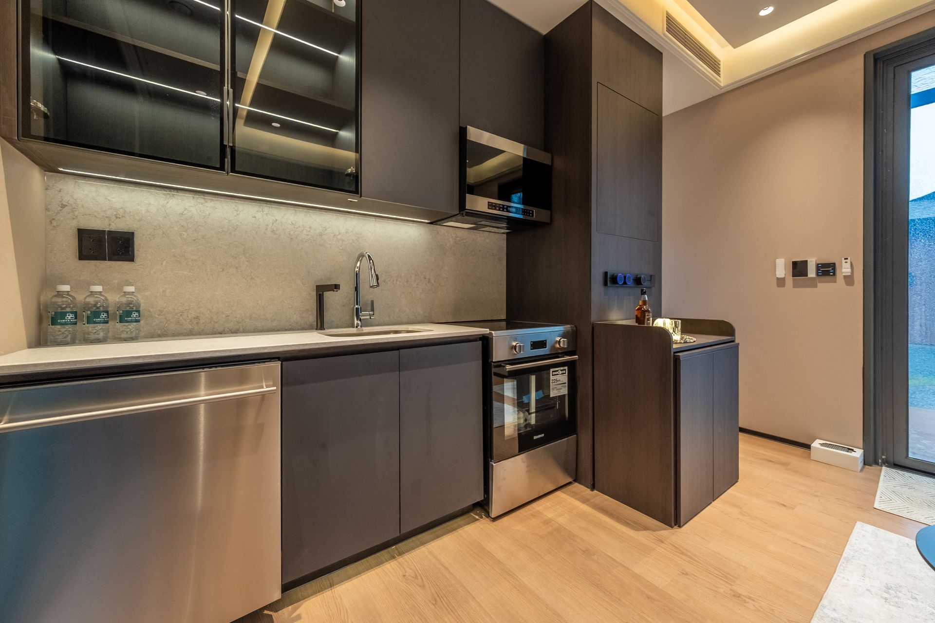 A living room with wooden shelves and a flat screen tv