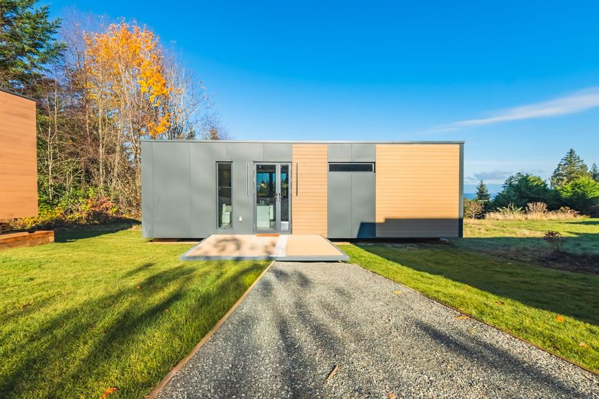 A modern house with a large deck and stairs