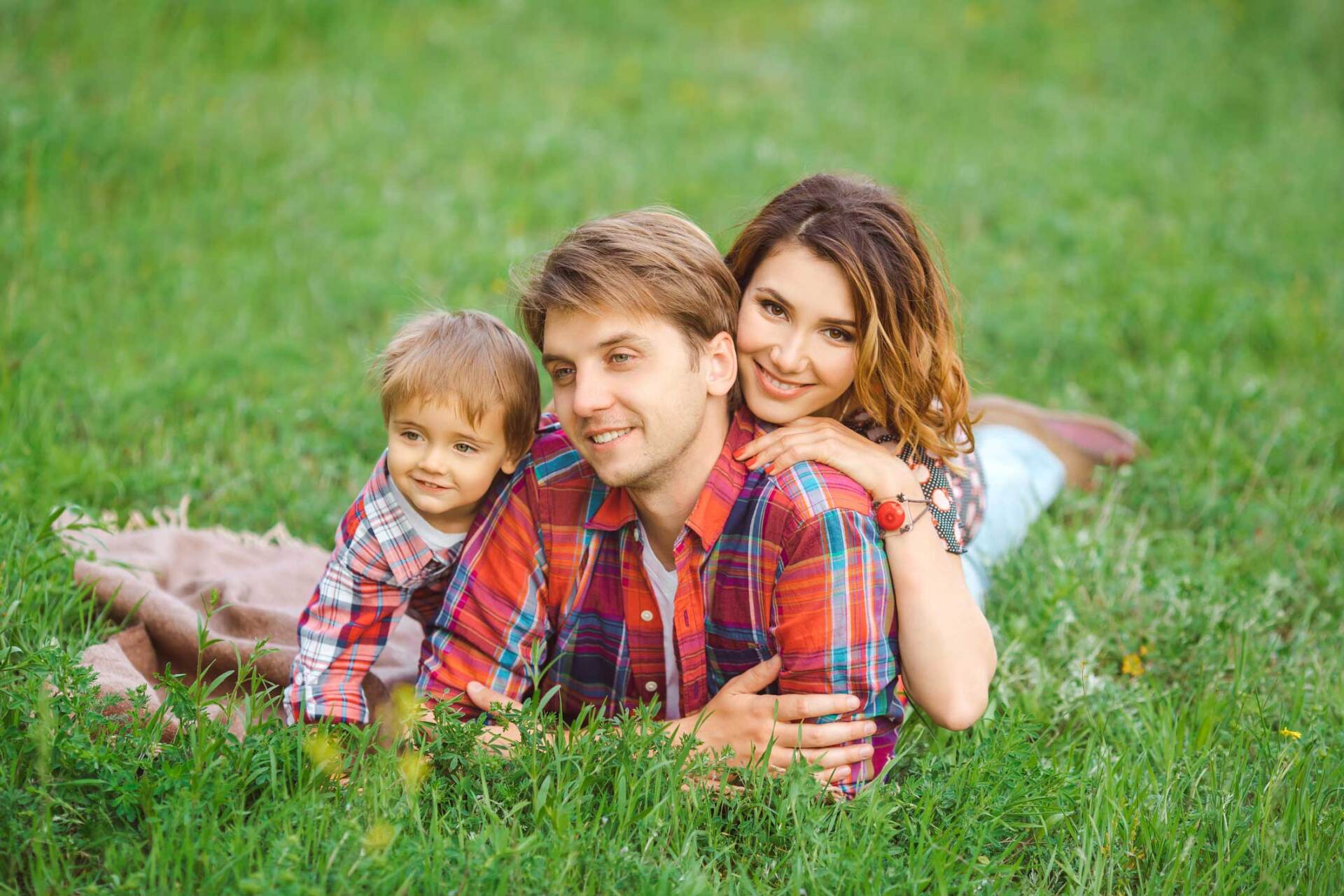 Family Lying Down on Grass — Gautier, MS — Coastal Insurance Associates, Ltd