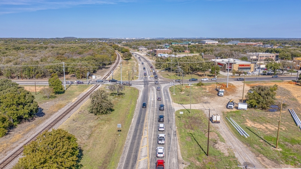 An aerial view of a busy highway intersection in a city.