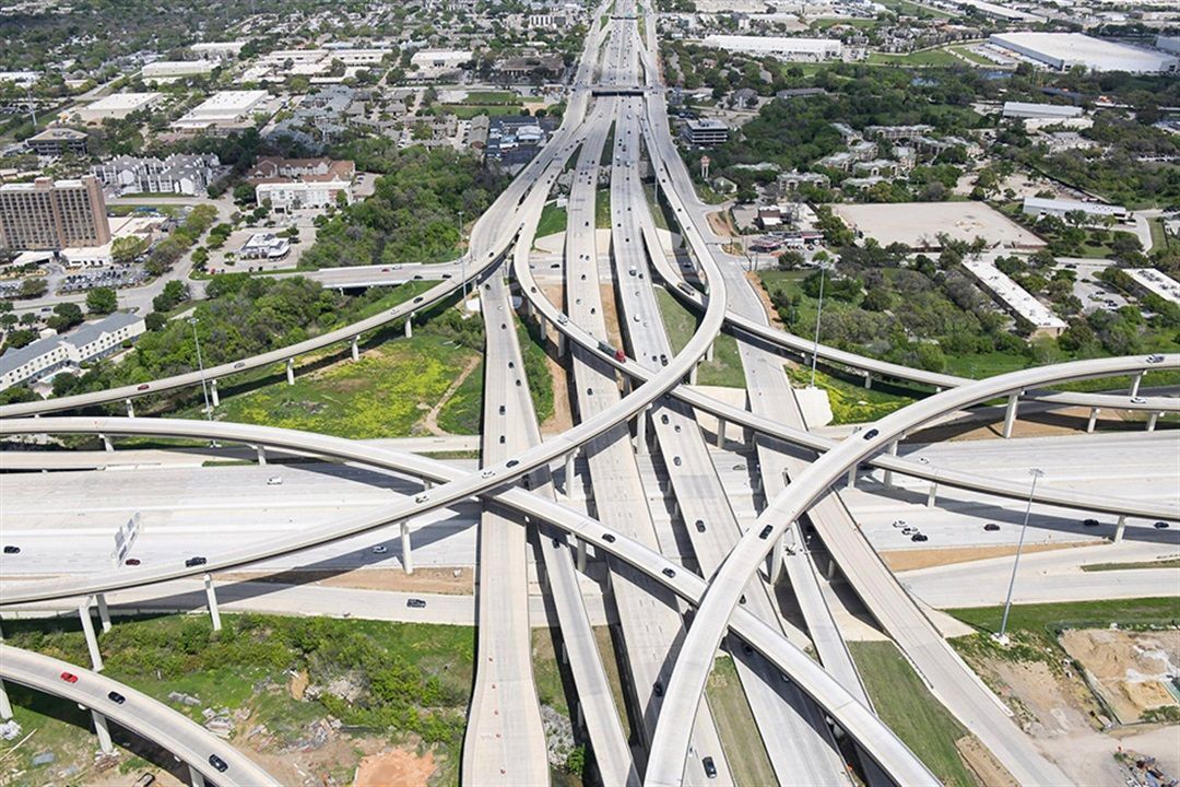 An aerial view of a highway intersection in a city.
