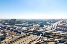 An aerial view of a highway intersection in a city.