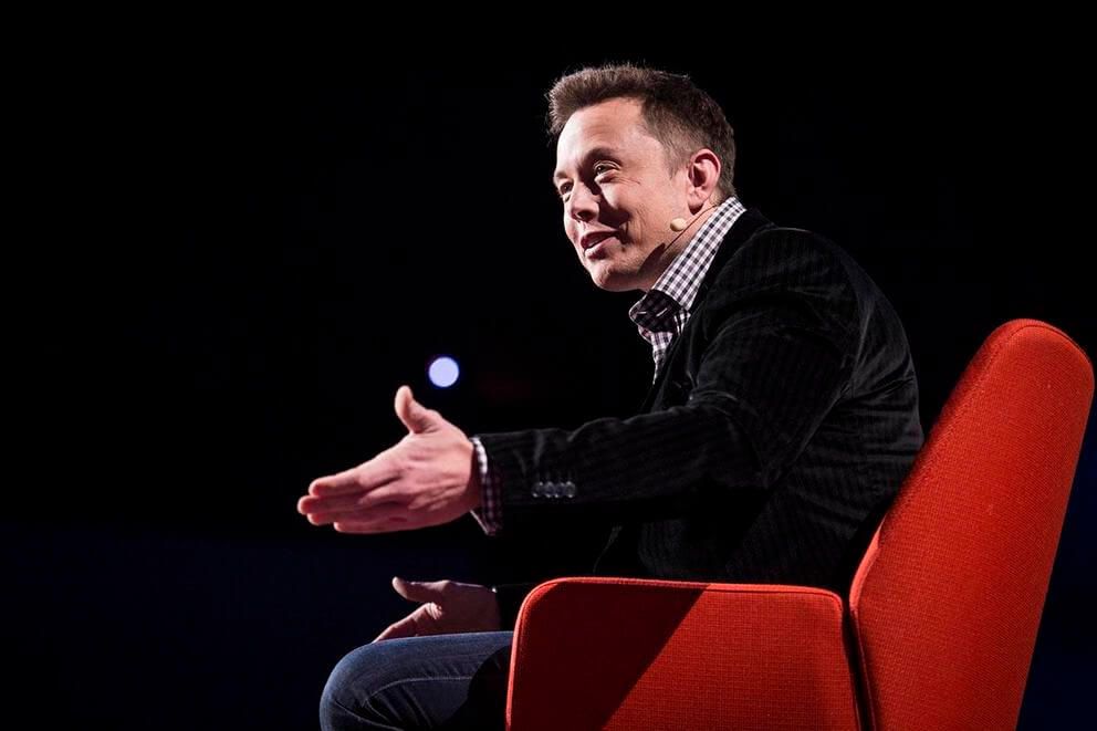 Elon Musk sitting down